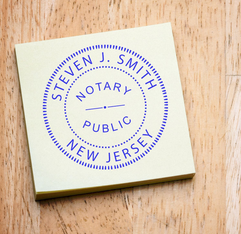 Custom Round Stamps blog post: A notary public stamp for Steven J. Smith, New Jersey, on a yellow sticky note, placed on a wooden surface.