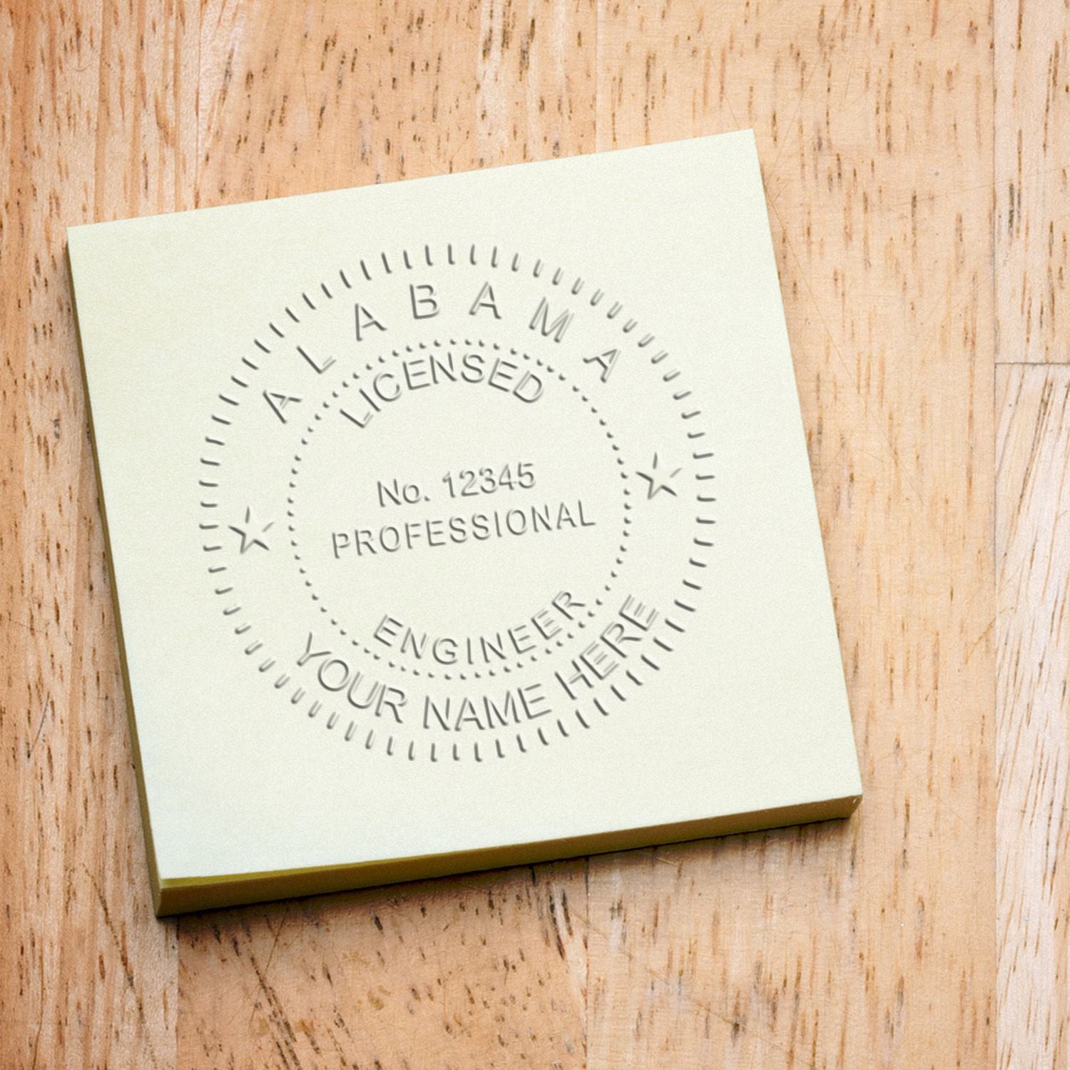 Alabama Engineer Embosser: A close-up of an embossed seal on a yellow paper, displaying 'Alabama Licensed Professional Engineer' with a placeholder for a name.