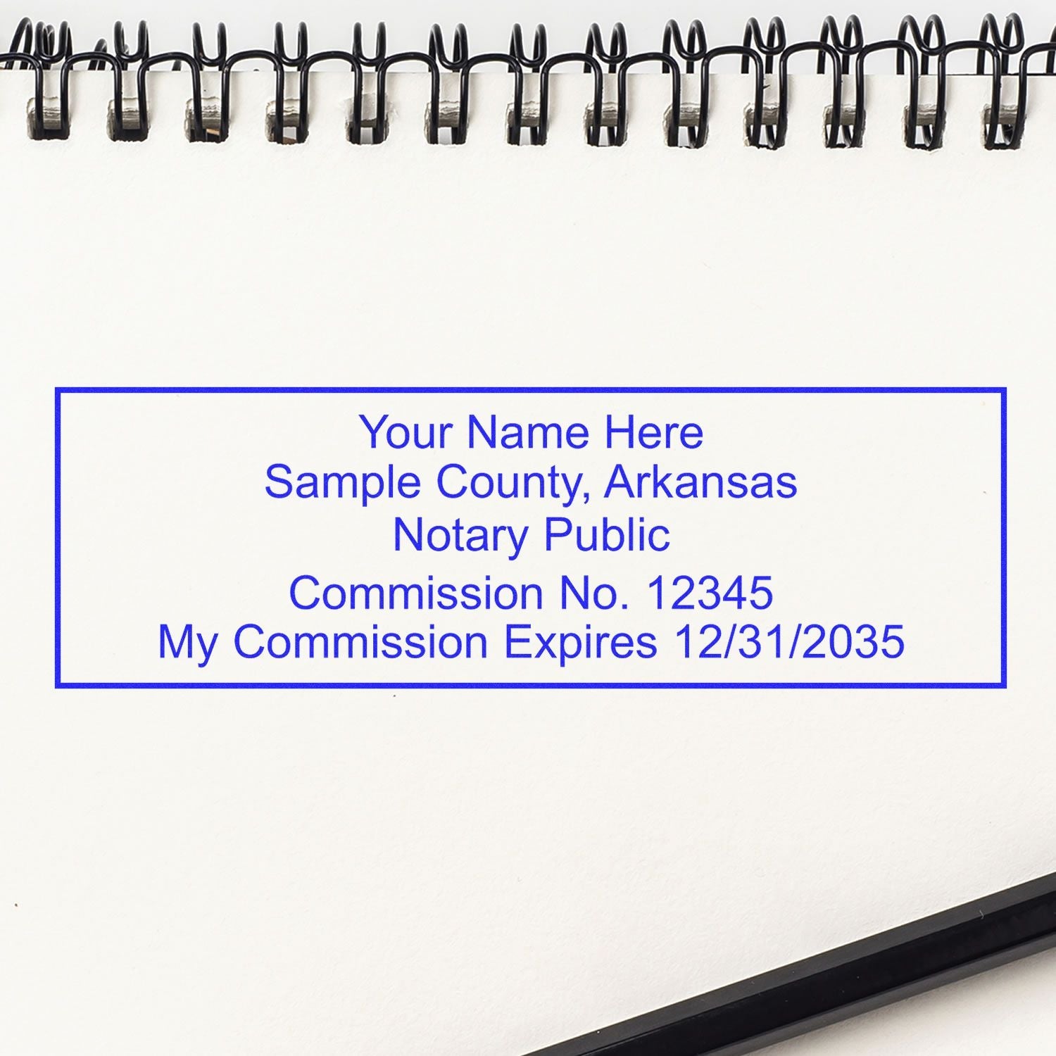 Image of a notary stamp impression on a spiral notebook with text: Arkansas Notary Stamp Selection Made Easy: Your Go-To Guide Feature Image.