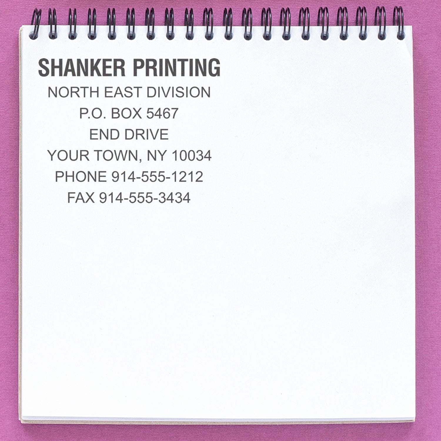 A notepad with Shanker Printing contact details on a purple background. Blog post: Maximize Warehouse Safety: The Best Inspection Stamps for You Feature Image.