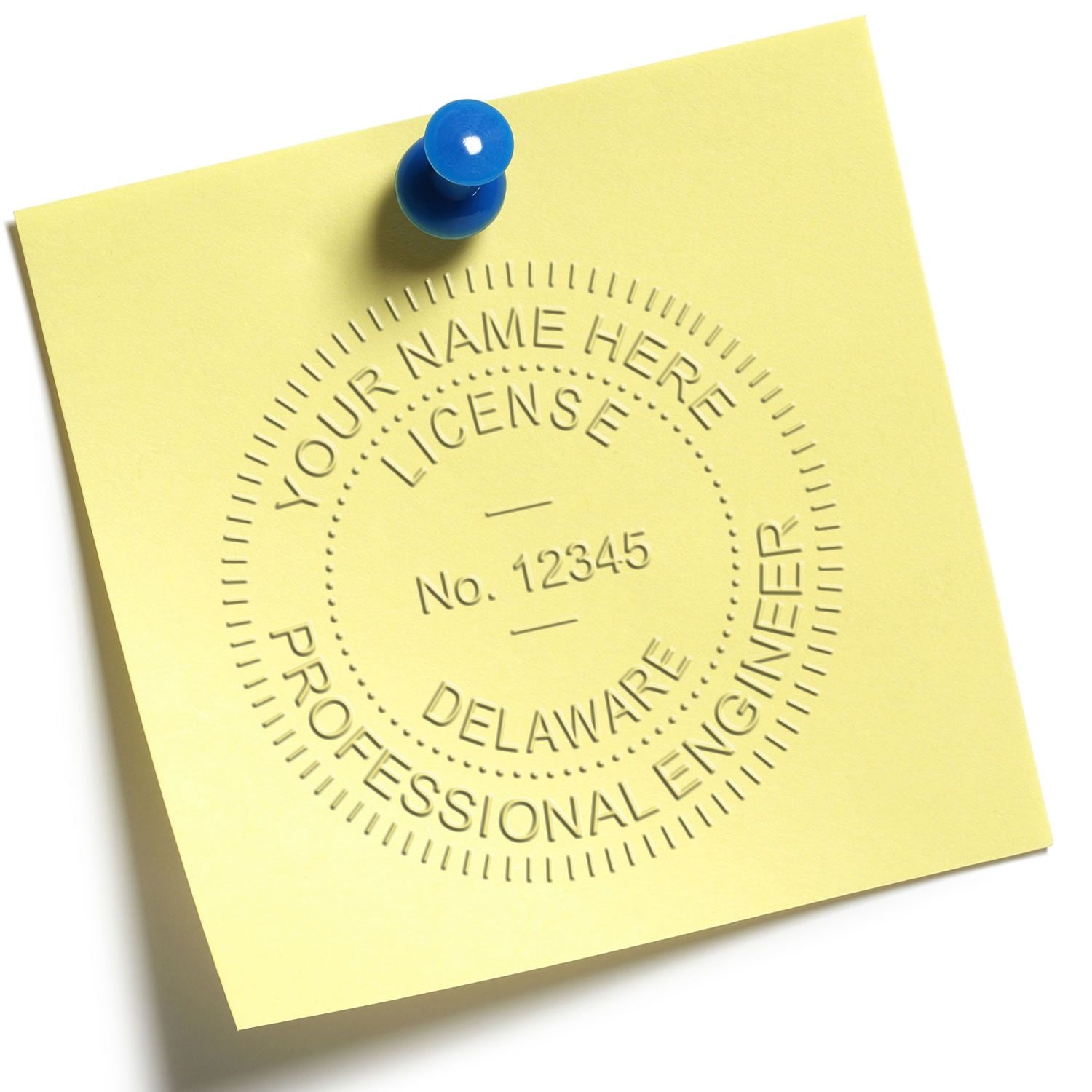 A yellow sticky note with a Delaware Engineer Embossing Stamp imprint, featured in the blog post 'Delaware Engineer Embossing Stamp.'