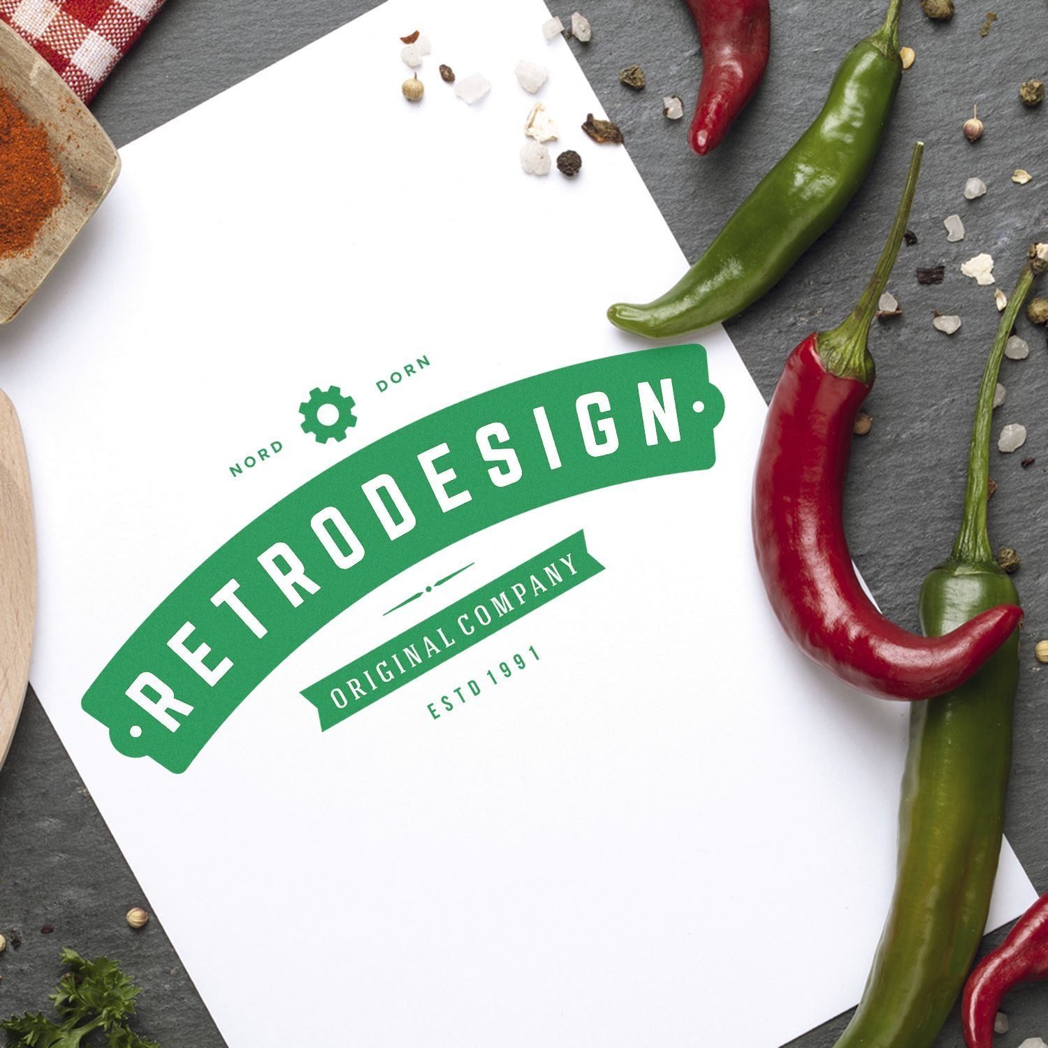 Discover The Art Of Branding With Rubber Stamps Blog Post Feature Image: Retrodesign logo stamped on paper surrounded by chili peppers and spices.