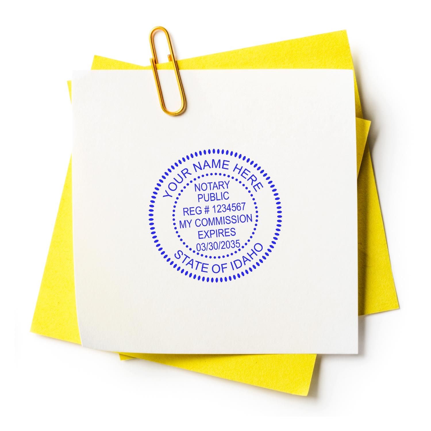 Image of a notary stamp on a white paper with yellow sticky notes and a paperclip. Idaho Notary Supplies Blog Post Feature Image.