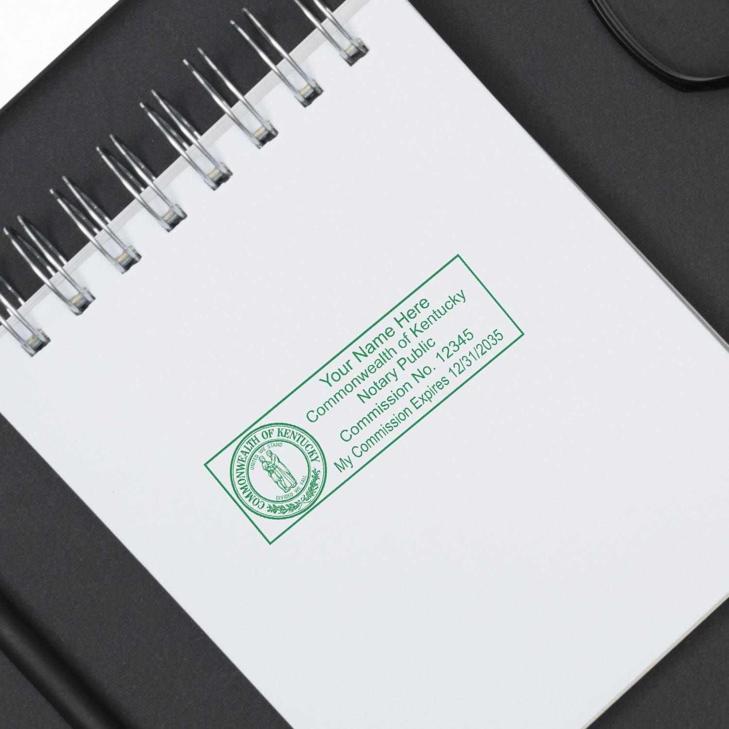 Kentucky Notary Supplies Blog Post Feature Image: A rectangular notary stamp impression on a white notepad with Kentucky state seal.