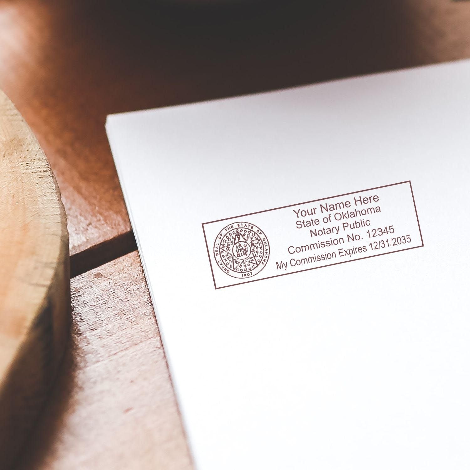 Alt Text: Oklahoma Notary Supplies Blog Post Feature Image: A notary stamp on a document with text State of Oklahoma Notary Public on a wooden table.