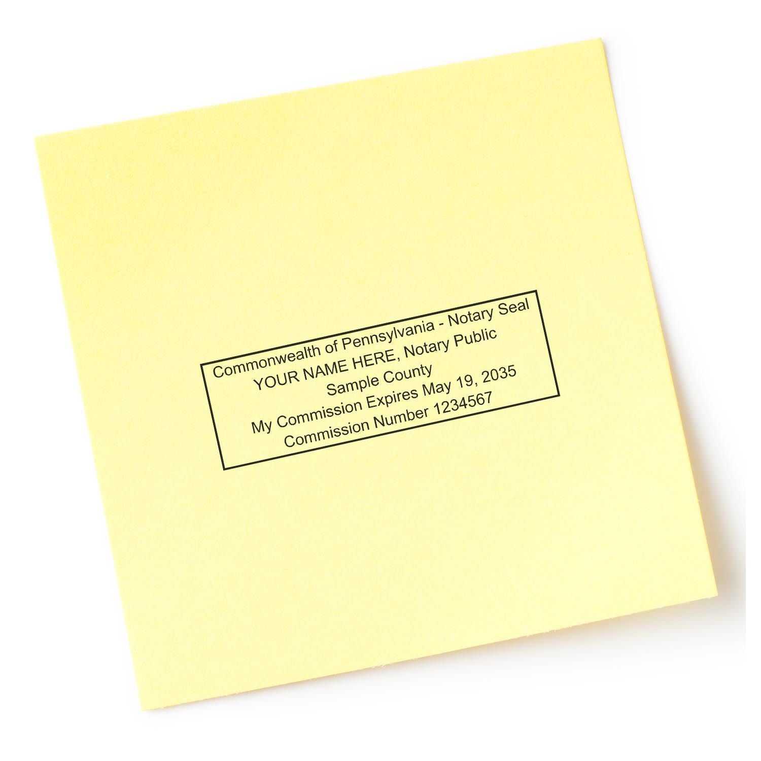 Pennsylvania Notary Supplies Blog Post Feature Image: A rectangular notary stamp impression on a yellow paper with sample text.