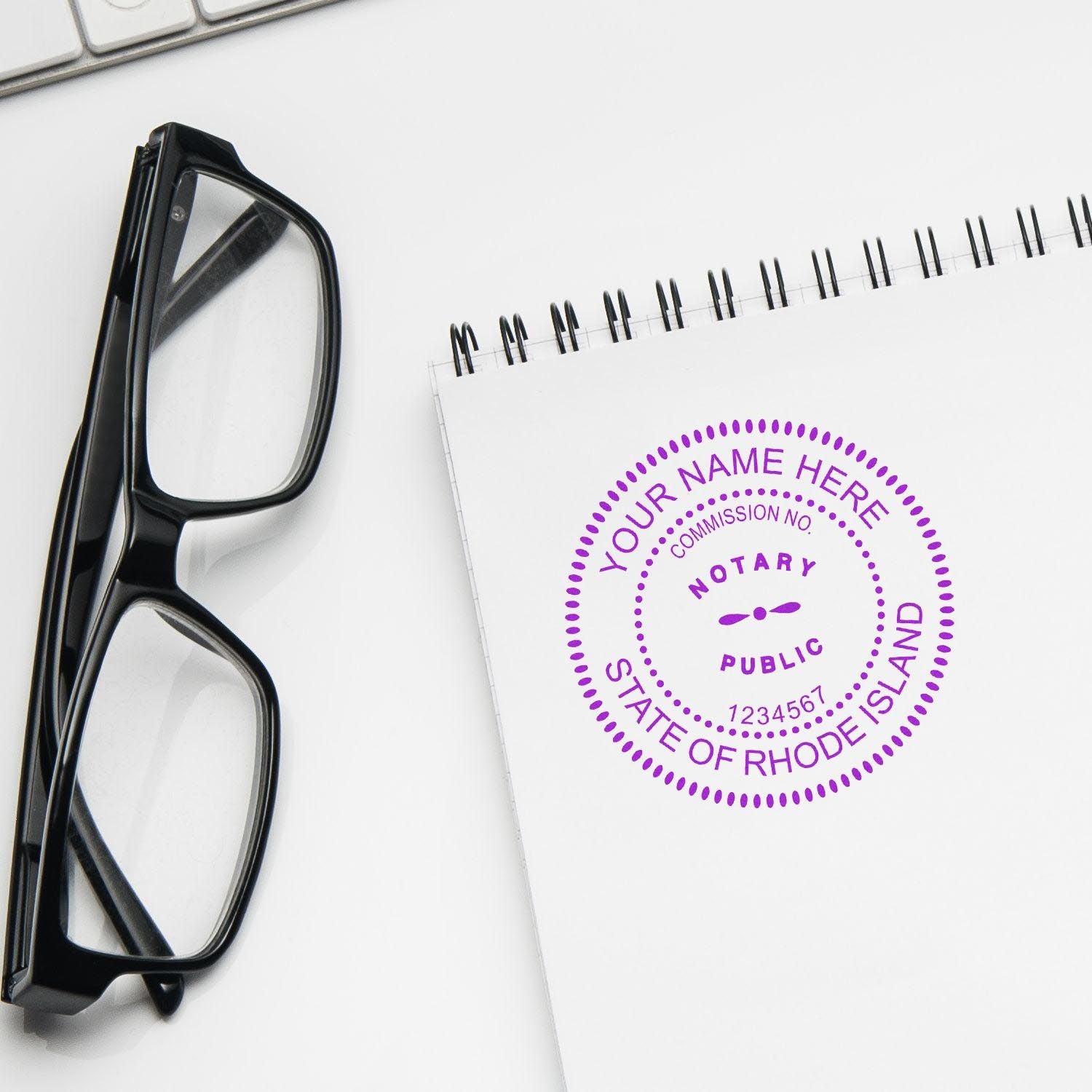 Rhode Island Notary Supplies Blog Post Feature Image: Notary stamp on a notepad beside glasses and a keyboard.