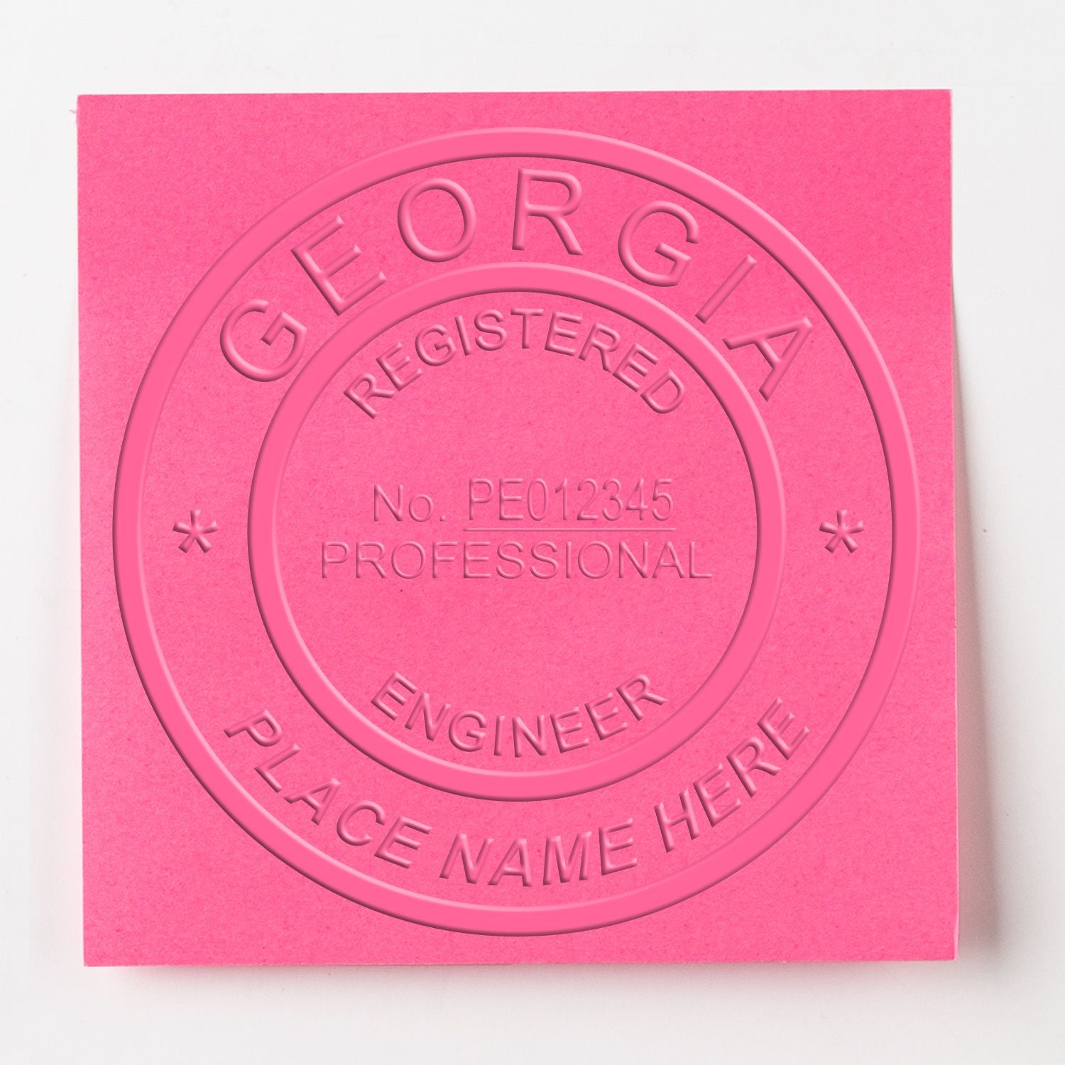 Embossed Georgia Engineer Seal on pink paper, displaying 'Registered Professional Engineer' and 'Place Name Here'. Blog post: Georgia Engineer Seal.