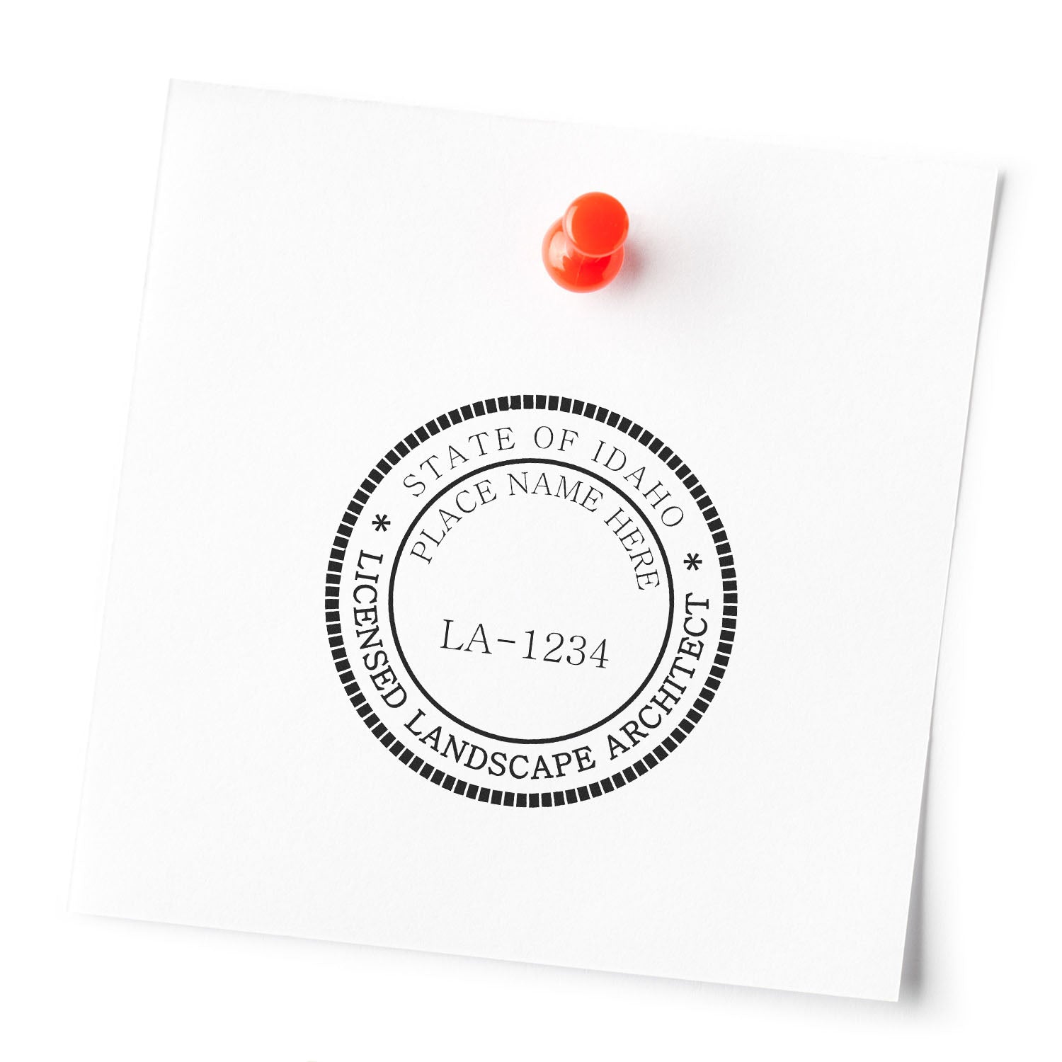 Image of a seal stamp for a licensed landscape architect in Idaho pinned to a white surface. Blog post: Idaho Landscape Architect Feature Image.