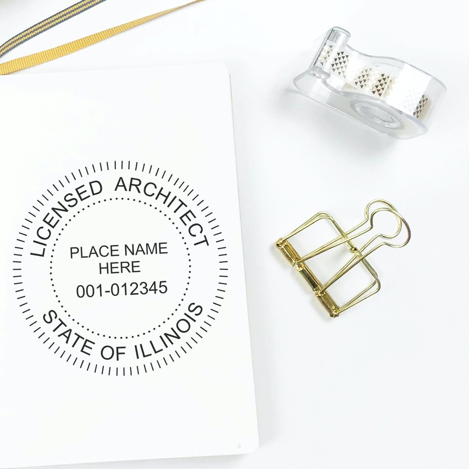 Seal of Success: Secure Your Illinois Architect Stamp Online Feature Image. Image shows an Illinois architect stamp, binder clip, and tape.