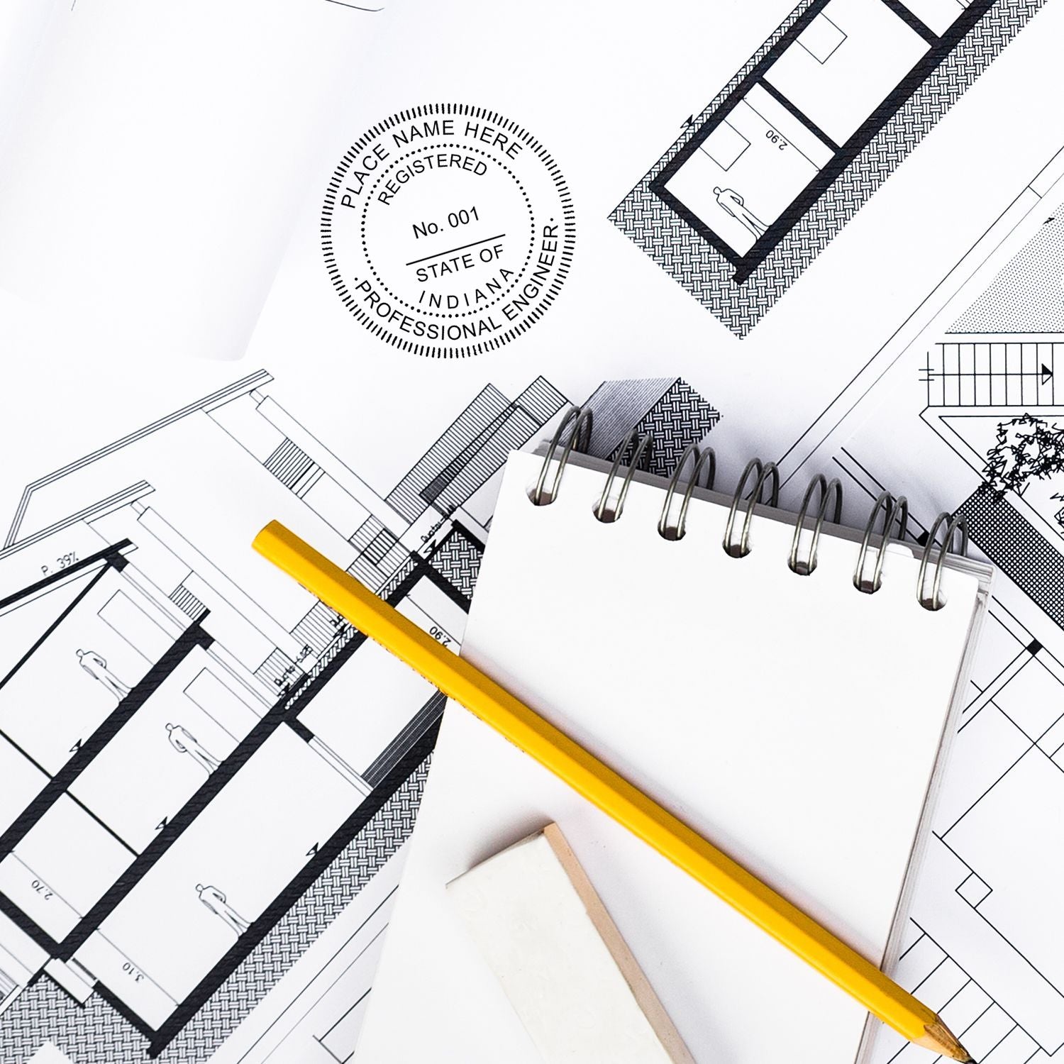 Indiana Professional Engineer blog post image showing an engineering seal stamp, architectural blueprints, a yellow pencil, and a notepad.