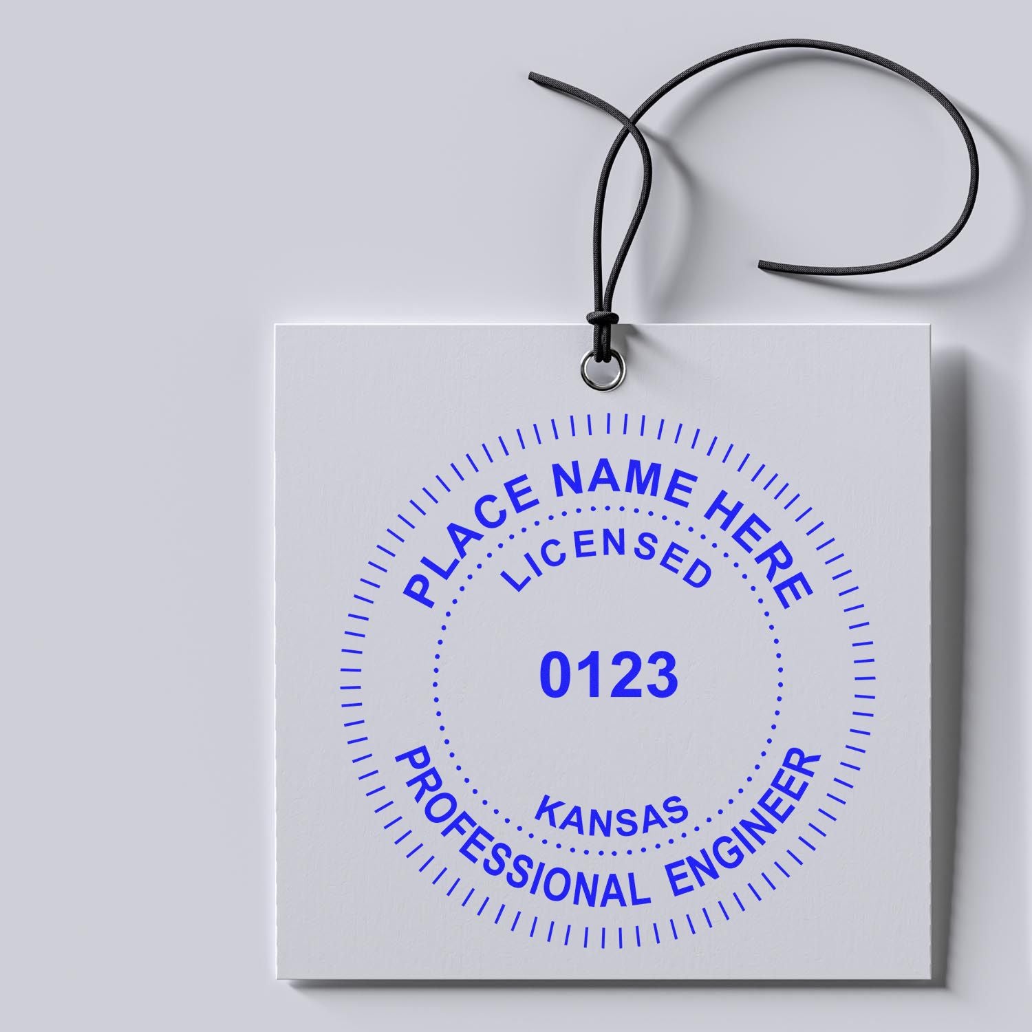 Image of a Kansas Professional Engineer stamp with text PLACE NAME HERE and 0123. Blog post: Renew Your Engineering Success: Kansas PE Stamp Renewal Guide.