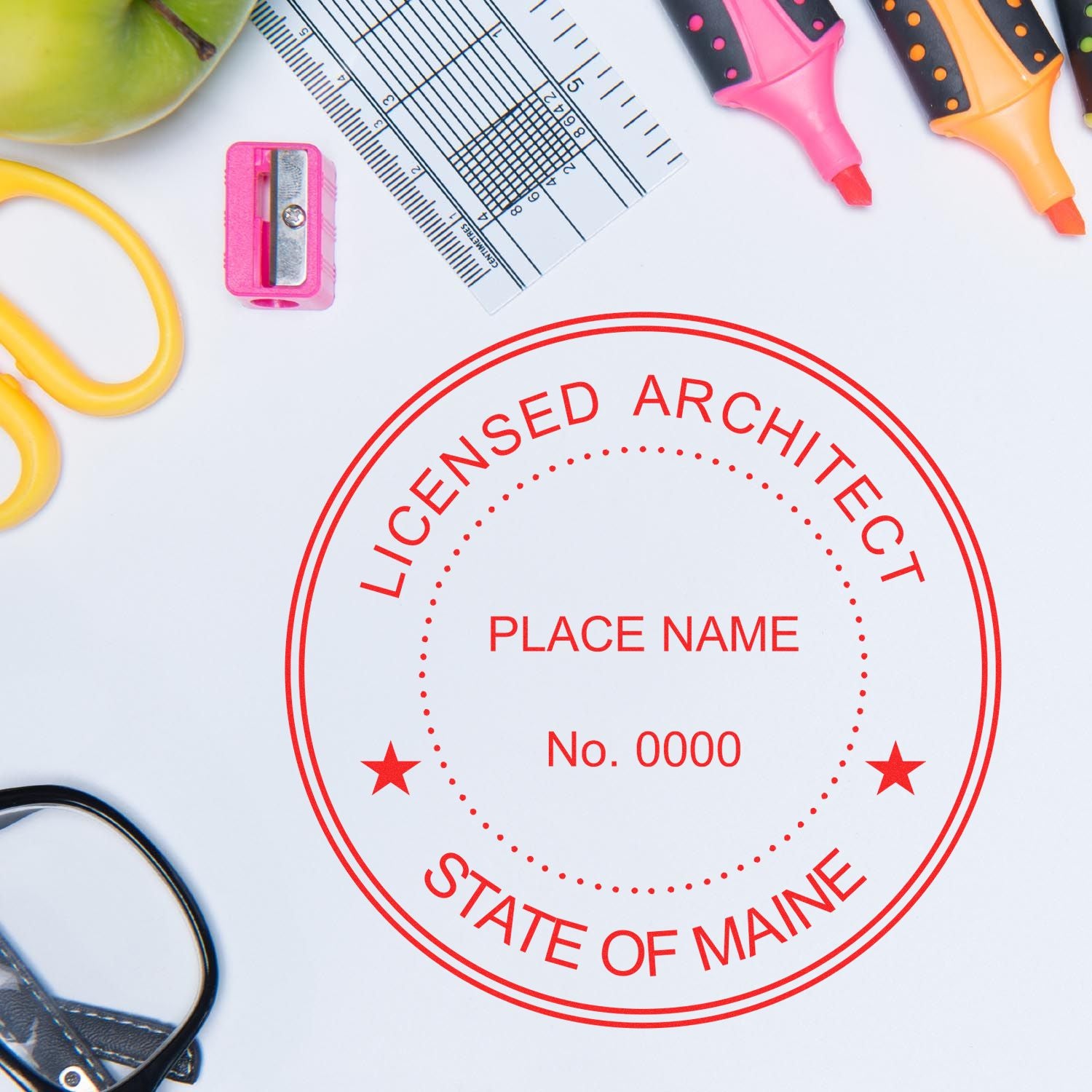 Ready, Set, Seal: The Key to Architectural Success in Maine Feature Image. Licensed Architect stamp with office supplies on a white background.