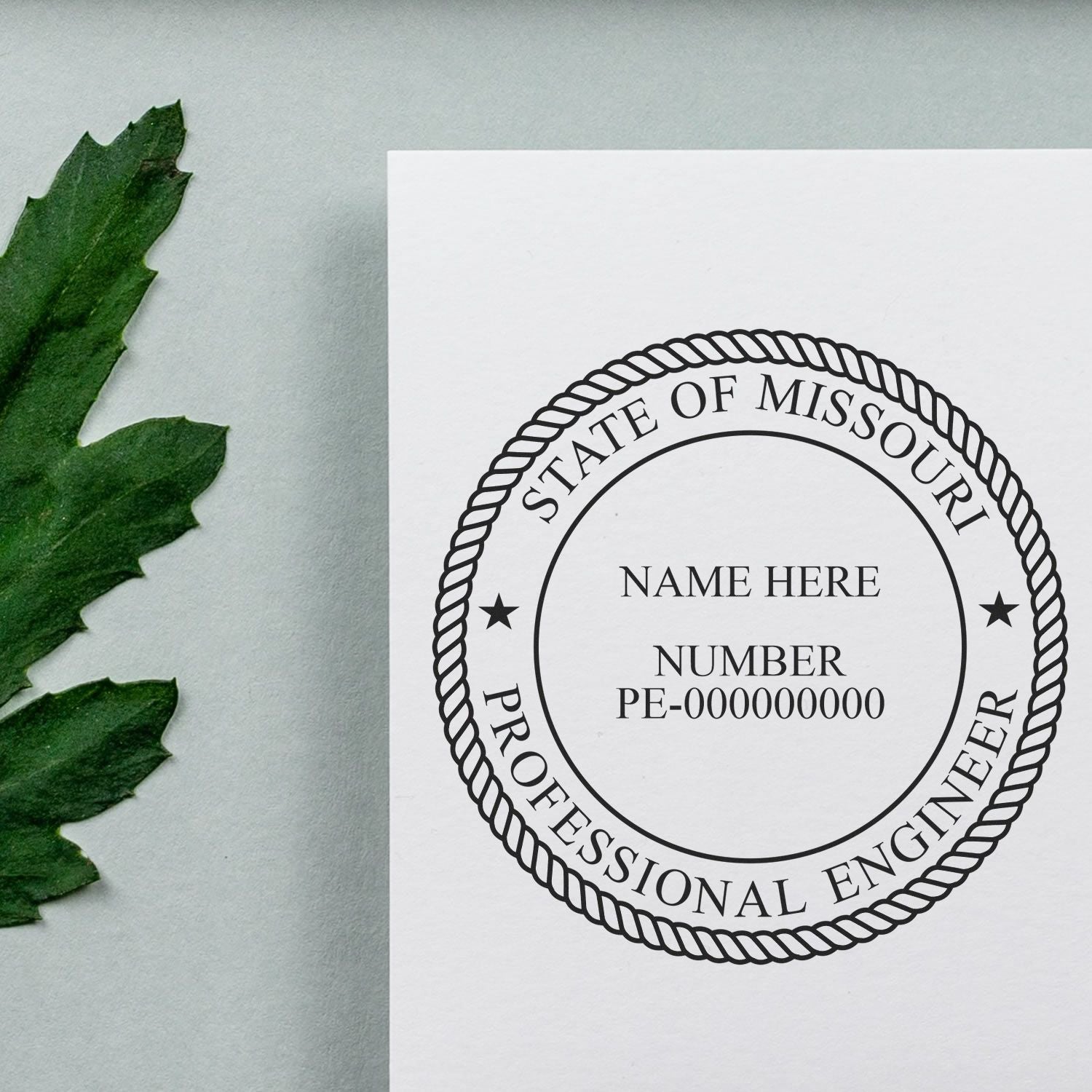 Image of a Missouri Professional Engineer stamp on paper next to a green leaf. Blog post: Cracking the Code: Unlocking Missouri PE Stamp Regulations.