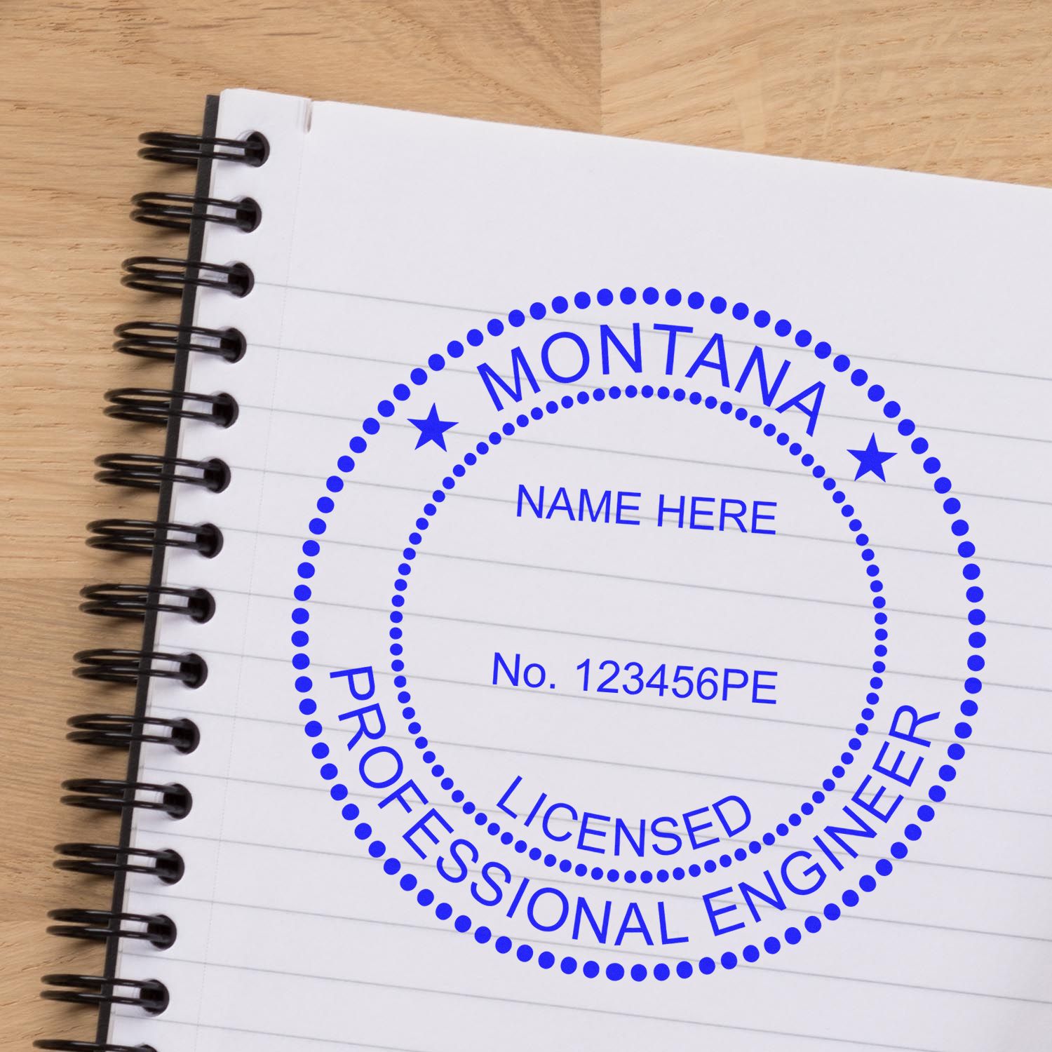 Image of a notebook with a blue Montana Professional Engineer stamp. Blog post: Unlocking the Secrets: Montana's Engineering Stamp Regulations.