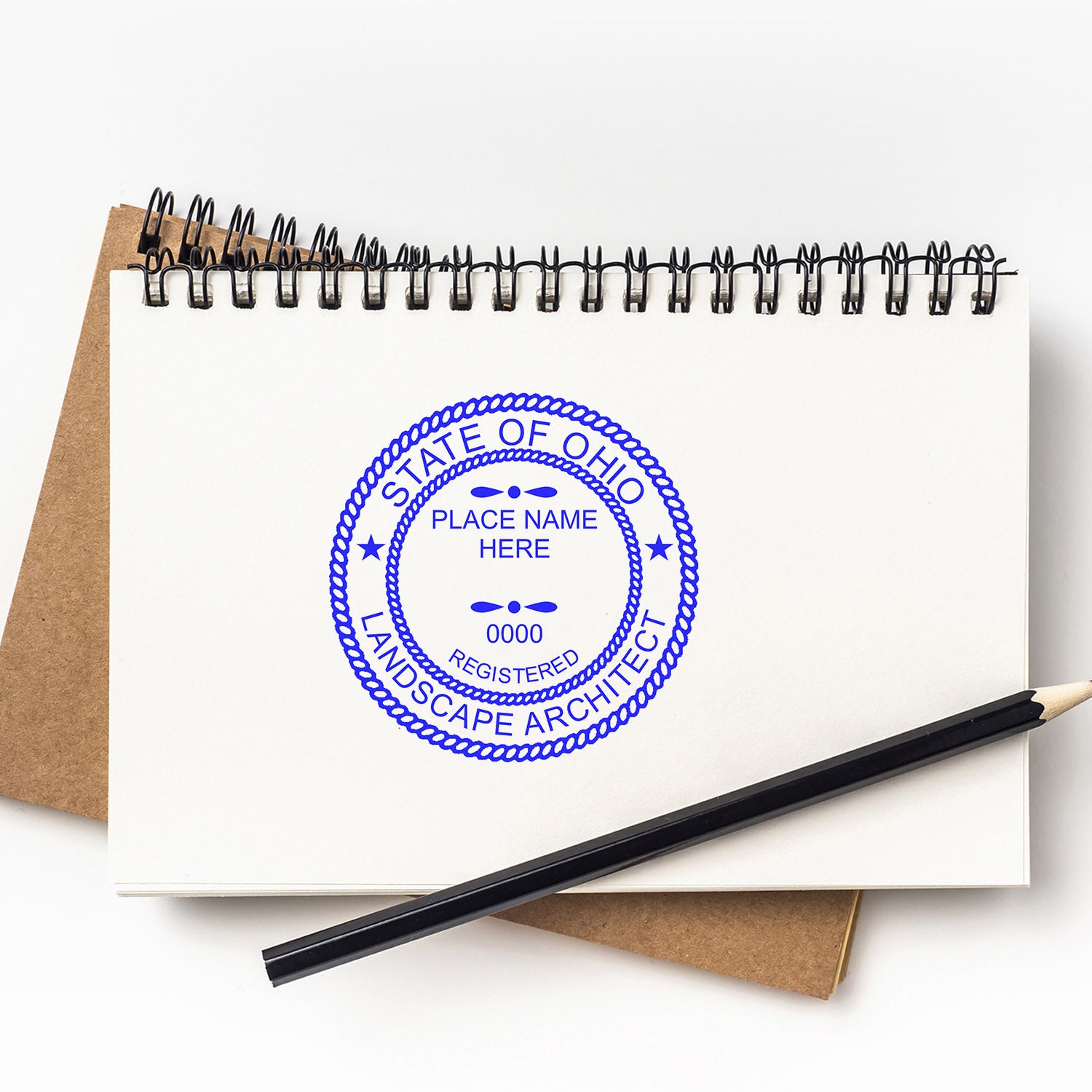 Ohio Landscape Architect Feature Image: A notebook with a blue State of Ohio Landscape Architect seal stamp and a black pencil on top.