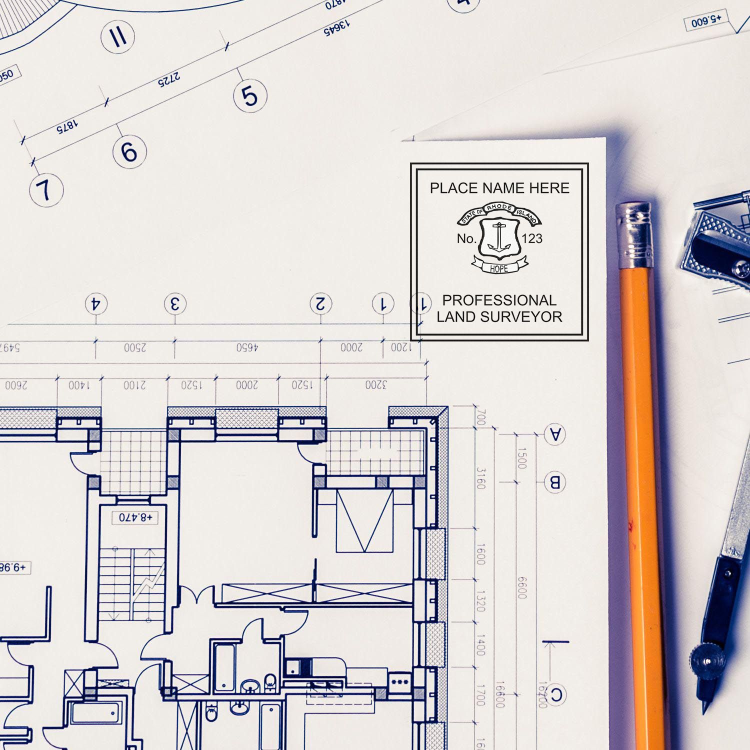 Blueprints with a Rhode Island Land Surveyor Seal, pencil, and compass. Blog post: Rhode Island Land Surveyor Seal.