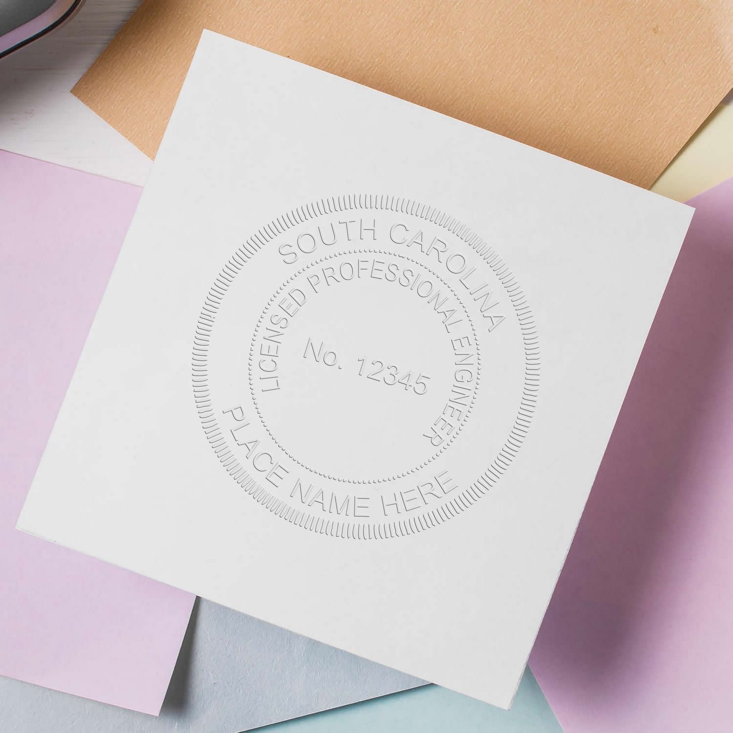 South Carolina Engineer’s Seal Embosser in use, displaying a professional engineer's embossed seal on a white sheet of paper.