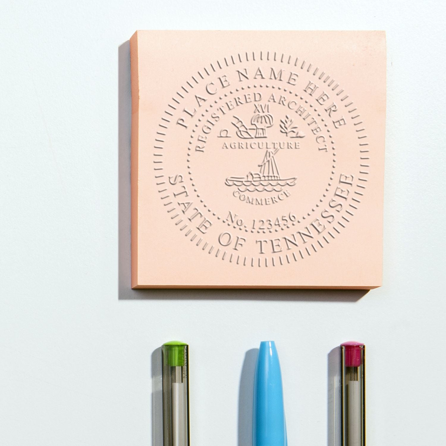 Image of a Tennessee Architecture Stamp embossing seal on a pink square, with three pens below. Blog post: Tennessee Architecture Stamp.