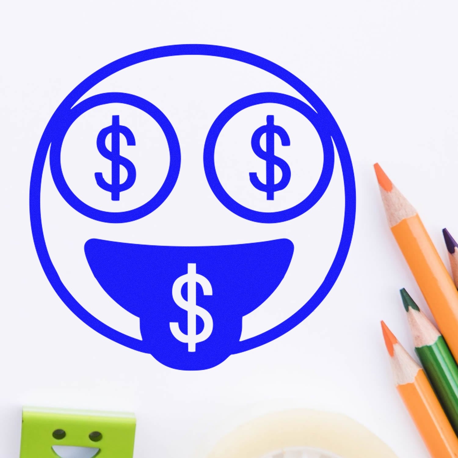 Wood Handle Money Eyes Facial Expressions Rubber Stamp featuring a blue smiley face with dollar signs for eyes and tongue, surrounded by colorful pencils on a white background.