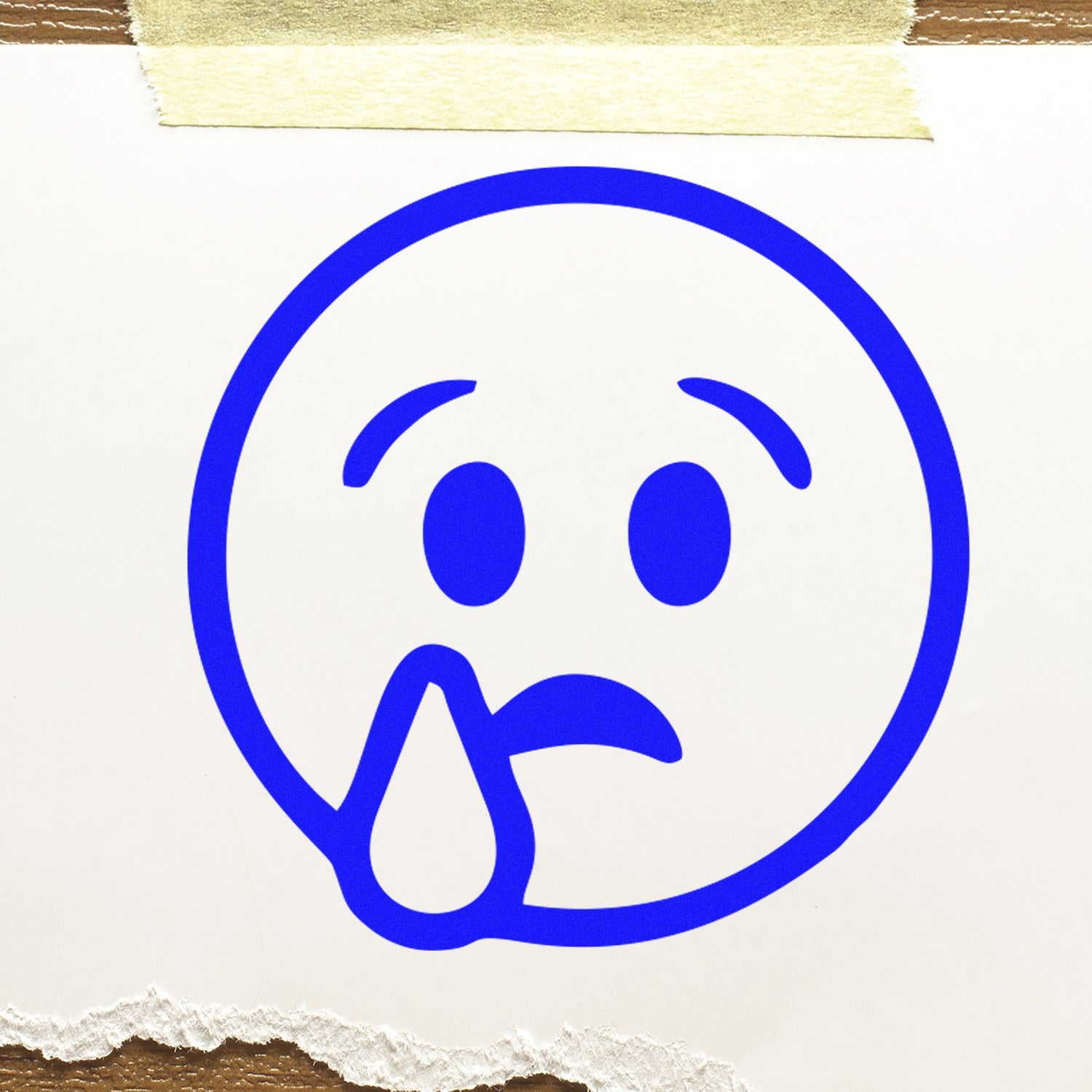 Self-Inking Sorrowful Droop Smiley Stamp with a blue sad face and tear design on white paper, showcasing its clear imprint and easy-to-use self-inking feature.