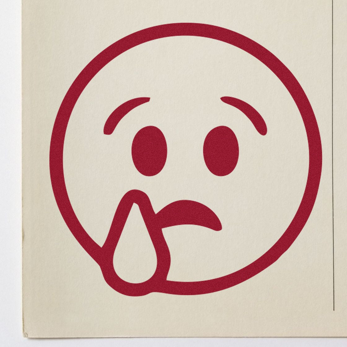 Self-Inking Sorrowful Droop Smiley Stamp featuring a red, sad face with a teardrop on beige paper. Perfect for adding a touch of emotion to your documents.