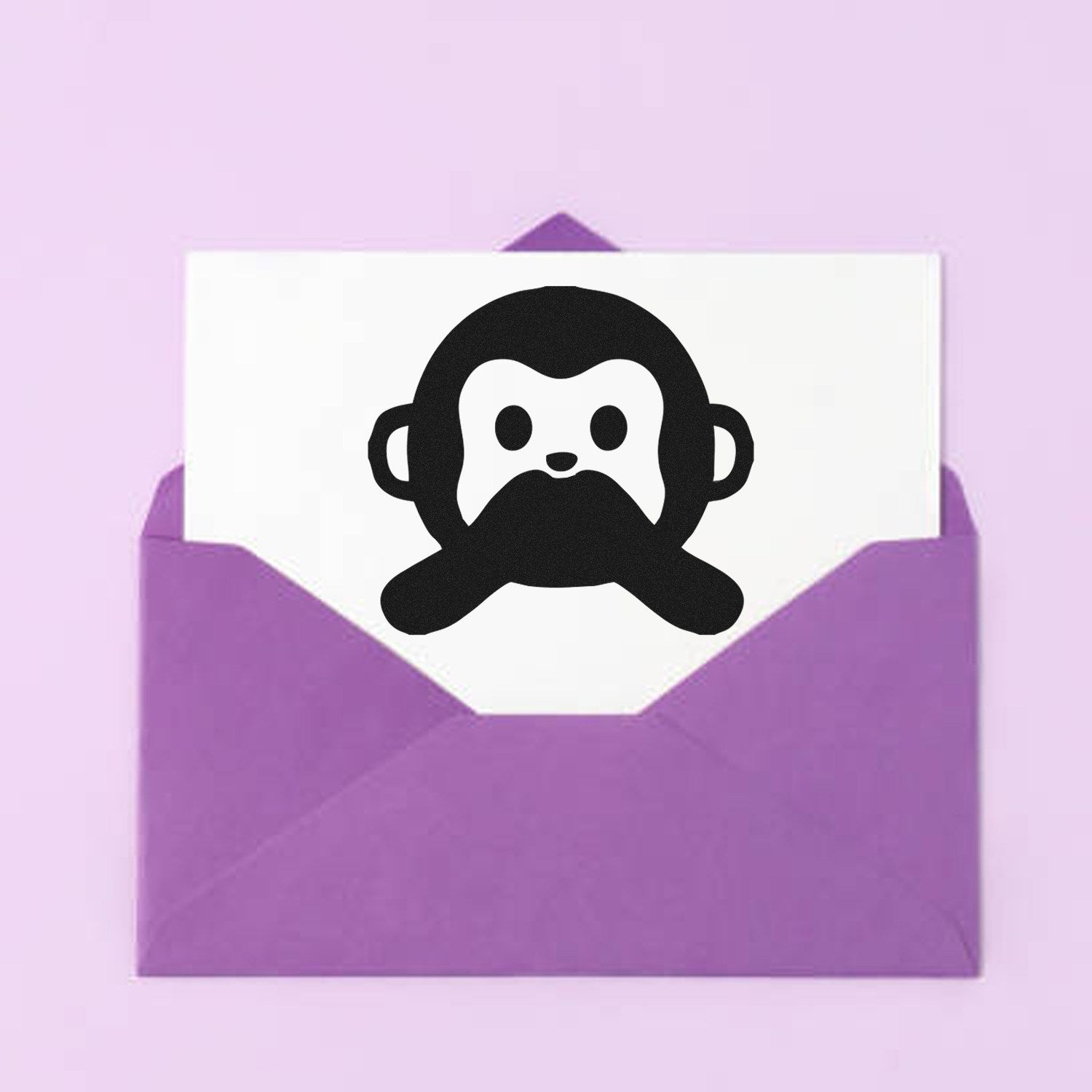 Image of a Wood Handle Mute Monkey Facial Expressions Rubber Stamp, featuring a cute monkey face design, displayed on a white card inside a purple envelope. Perfect for crafting and decoration.