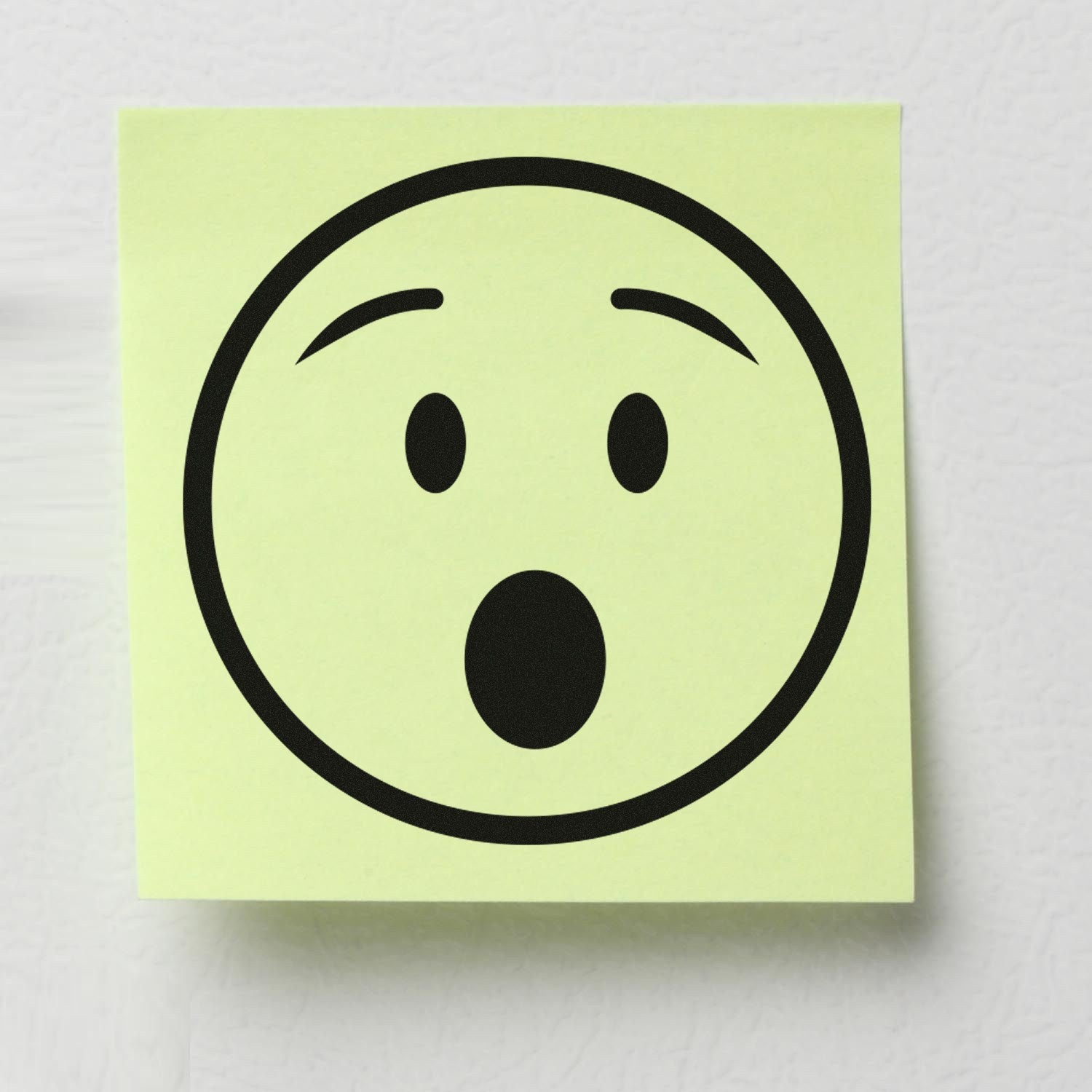 Self-Inking Amazed Andy Emotes Stamp on a yellow sticky note, featuring a surprised face design. Perfect for adding expressive flair to documents and crafts.