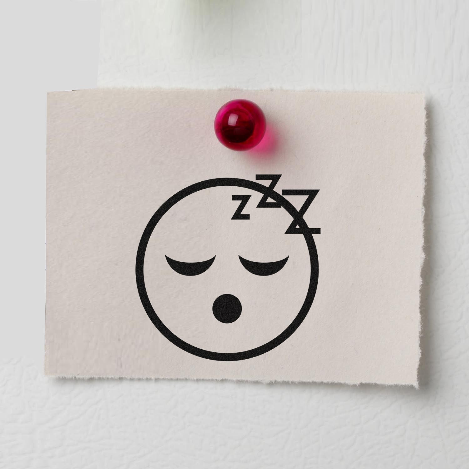 Image of the Self-Inking Sleepy Steve Reaction Stamp imprint on paper, featuring a sleepy face with closed eyes and Zzz symbols, pinned to a board. Perfect for adding fun reactions to documents.