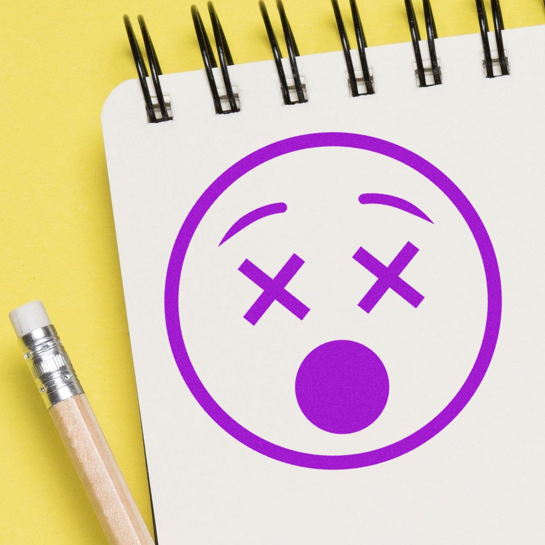 Self-Inking X'd Out Facial Expressions Stamp on notepad, featuring a purple face with X eyes and open mouth. Perfect for adding fun, expressive designs to your projects.