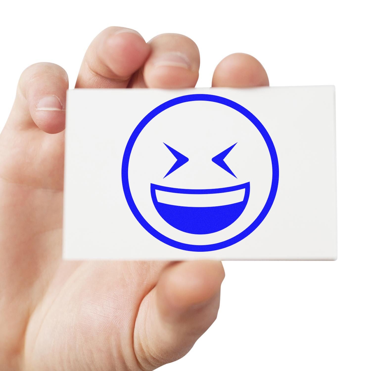 Self-Inking Excited Squint Emoji Stamp in use, featuring a blue, smiling emoji with squinting eyes on a white background, held in hand. Perfect for adding fun to documents and crafts.