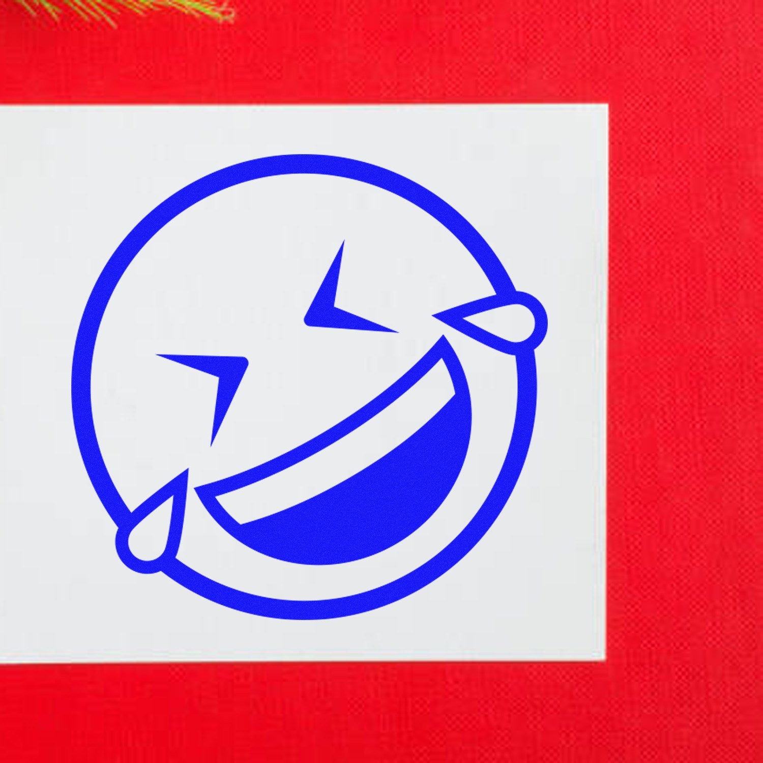 Self-Inking Laugh Riot Smiley Stamp with a blue laughing face design on a red background, perfect for adding fun to documents and crafts.