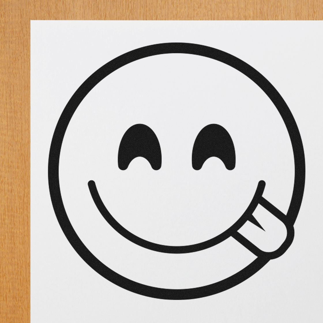 Self-Inking Cheeky Winky Emoji Stamp on paper, showcasing a playful winking face with tongue out. Perfect for adding fun to crafts and stationery.