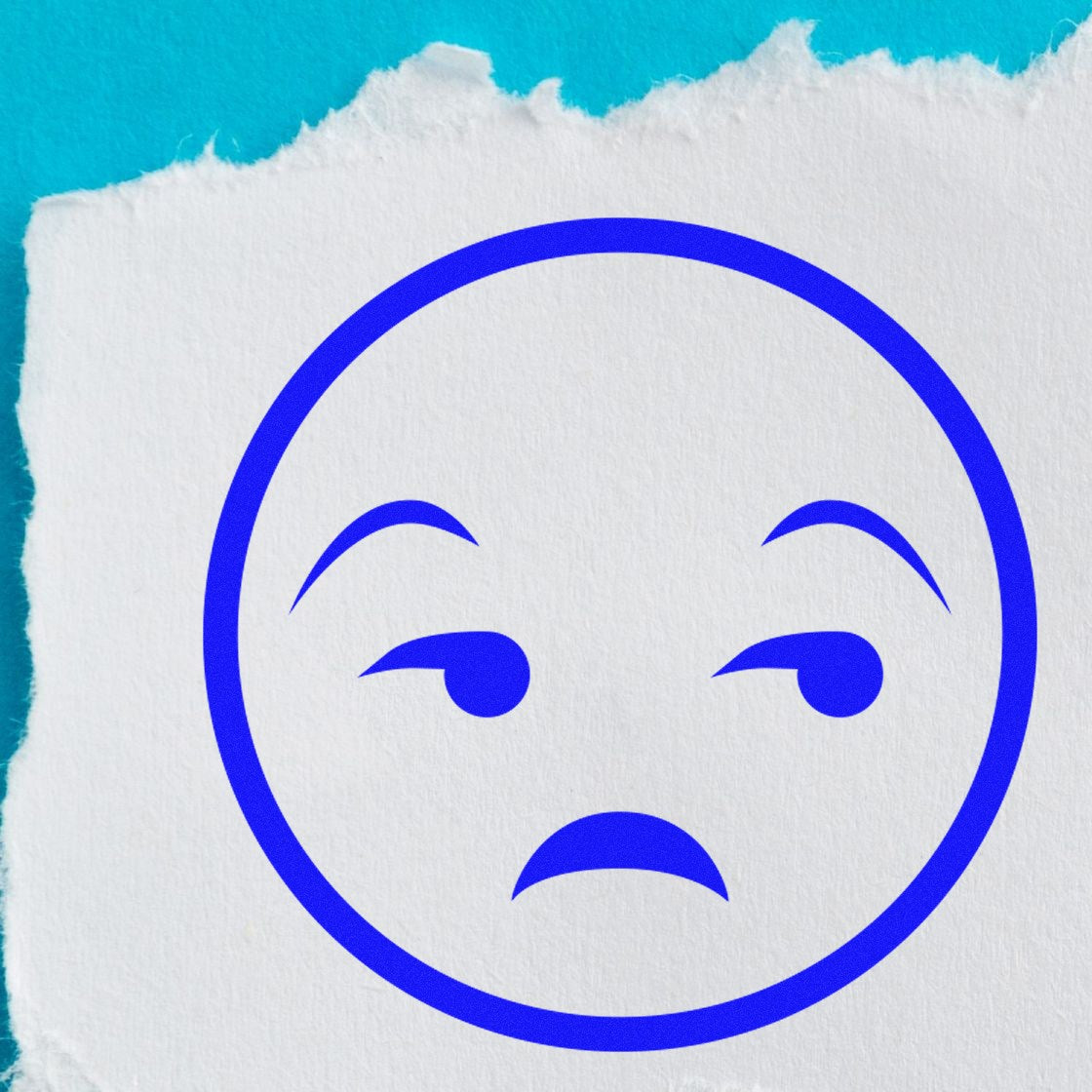 Self-Inking Grumpy Gus Facial Expressions Stamp featuring a blue grumpy face on torn white paper against a blue background. Perfect for adding personality to documents and crafts.