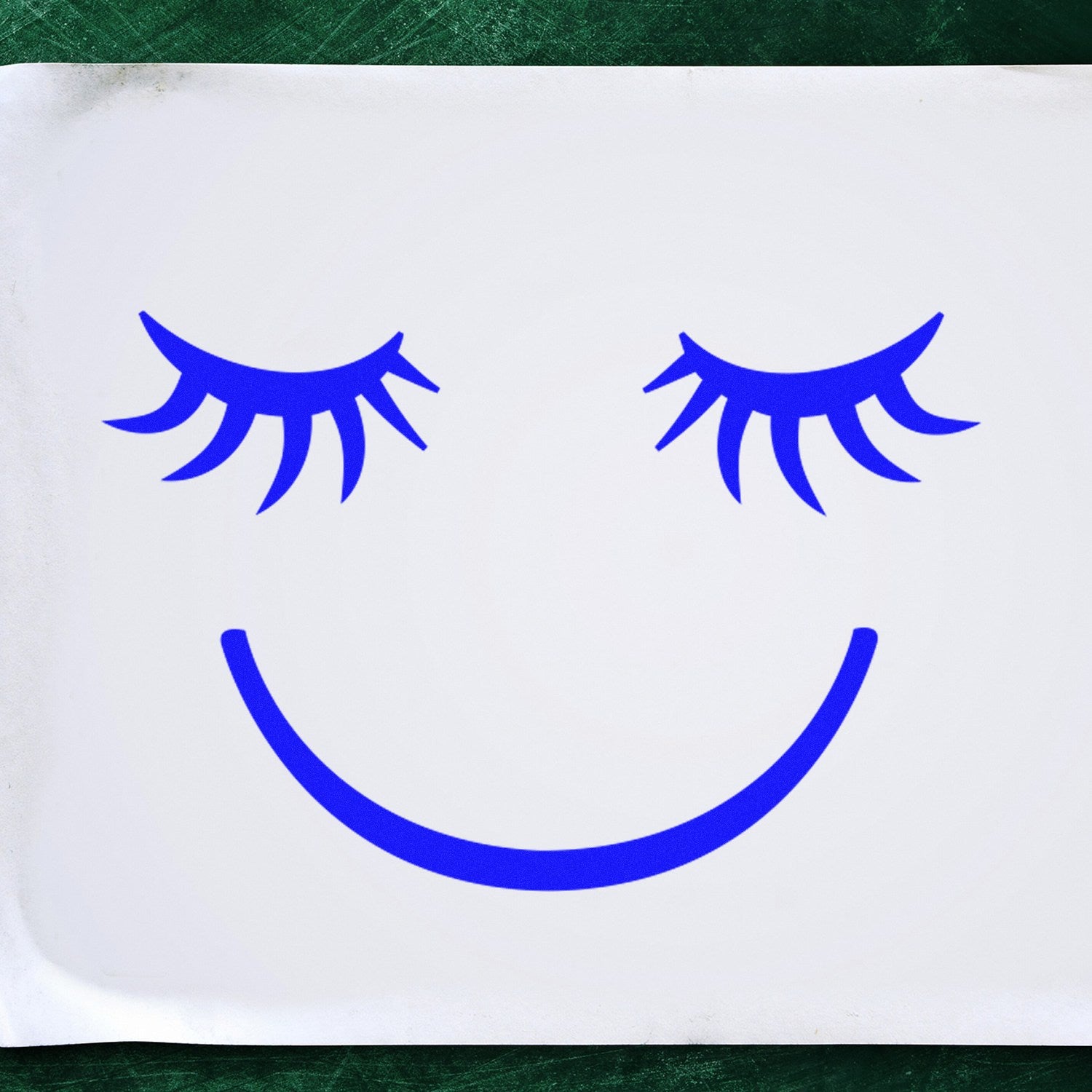 Self-Inking Dreamy Delight Pictogram Stamp featuring a blue smiling face with closed eyes on white paper, perfect for adding a cheerful touch to documents and crafts.