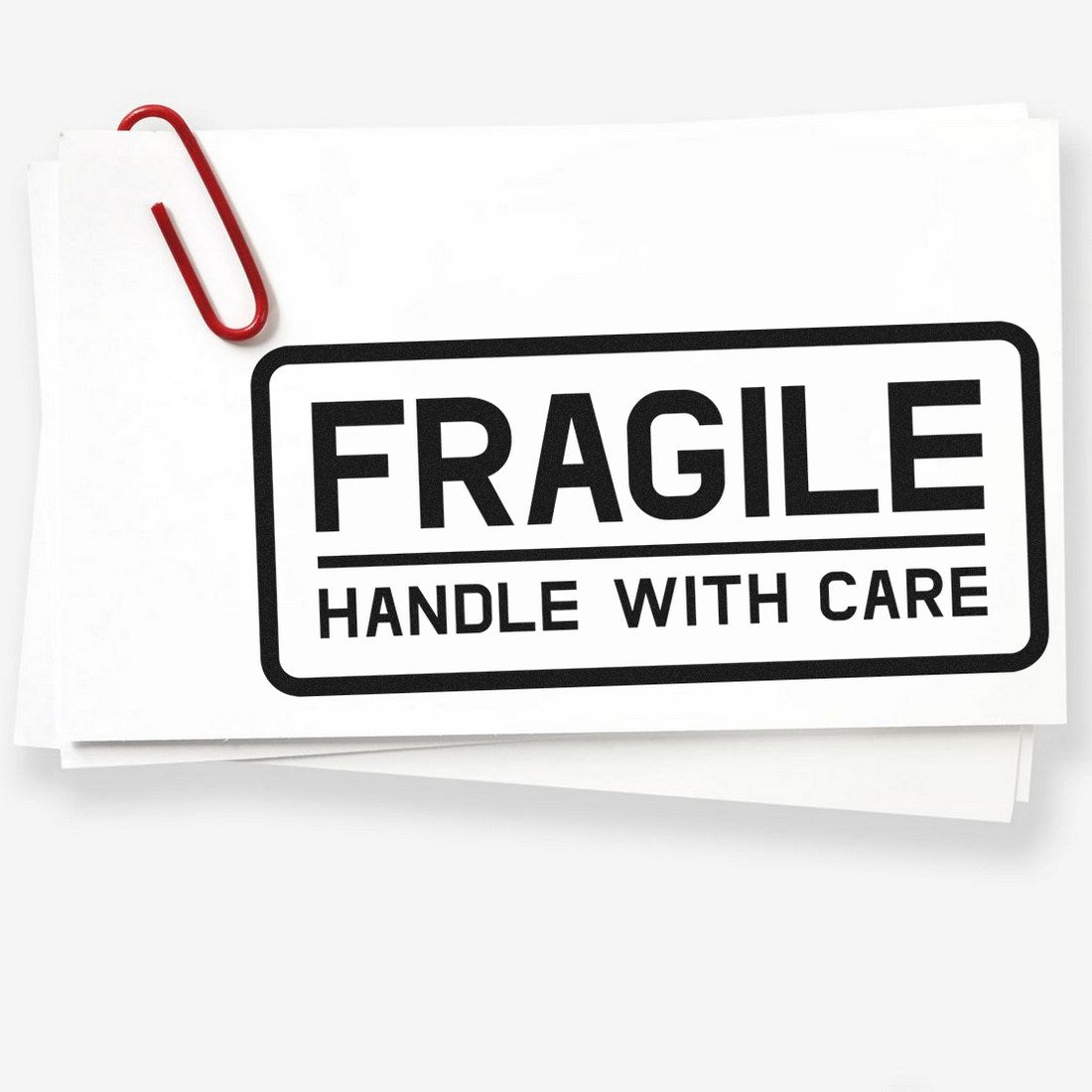 Image of the Slim Pre-Inked Fragile Handle With Care Shipping Stamp, featuring bold black text on a white background, ideal for marking packages.