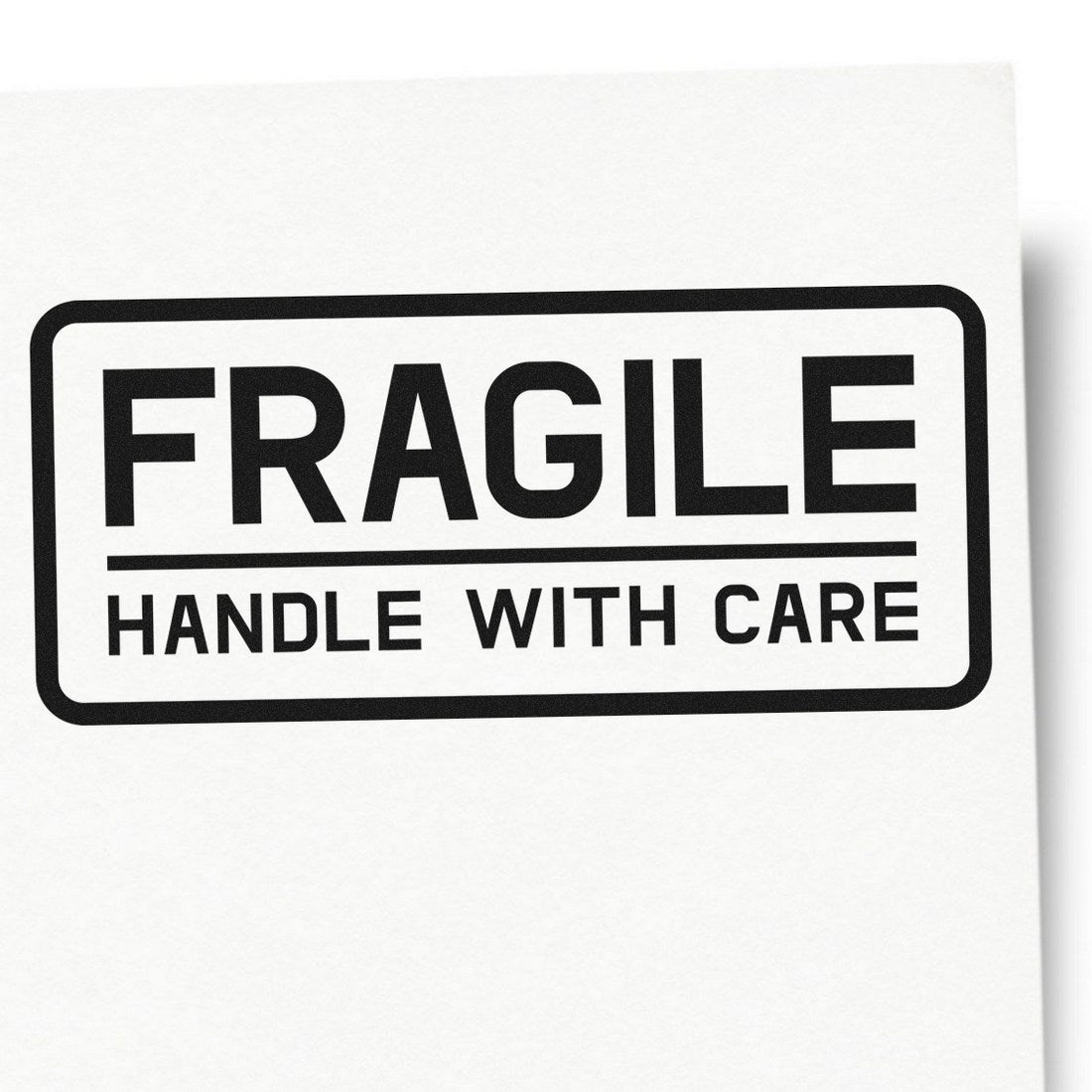 Slim Pre-Inked Fragile Handle With Care Shipping Stamp on white paper, featuring bold black text in a rectangular border, ideal for marking packages.