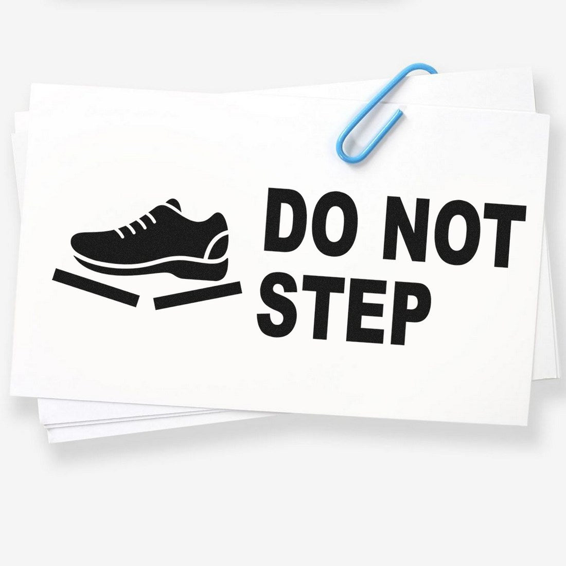 Image of a Slim Pre-Inked Handle With Care Do Not Step Stamp, featuring a shoe icon and bold Do Not Step text, ideal for marking fragile packages.