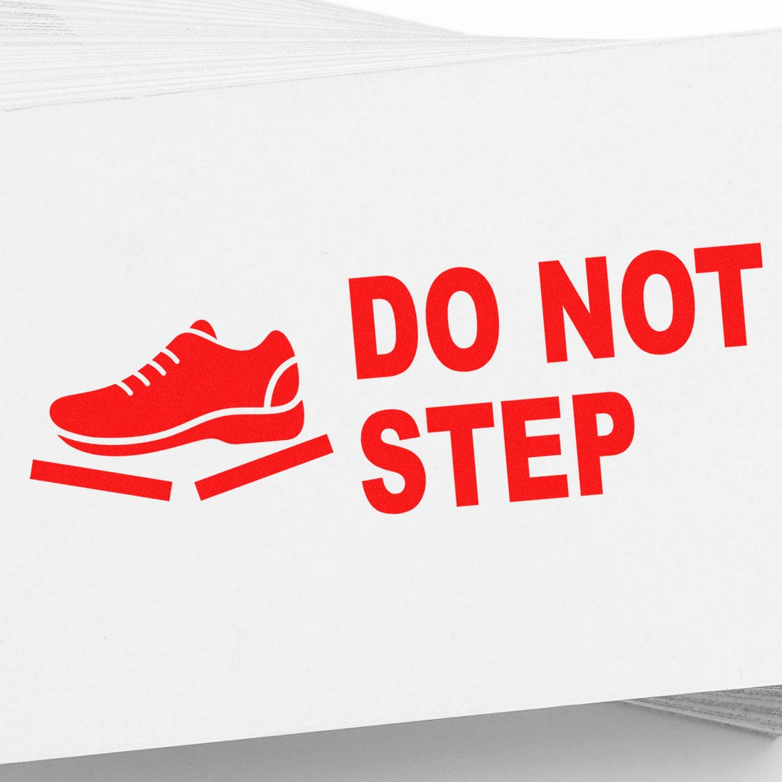 Image of the Slim Pre-Inked Handle With Care Do Not Step Stamp, featuring a red shoe icon and bold red text on a white background, ideal for marking fragile items.