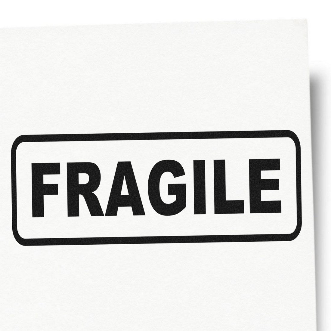 Slim Pre-Inked Fragile Stamp with bold black 'FRAGILE' text on a white background, ideal for marking packages. Compact design for easy handling and clear impressions.