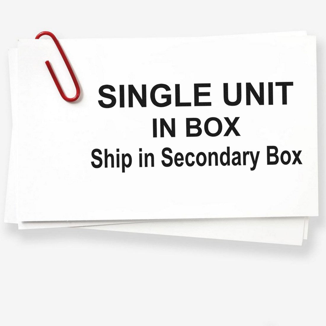 PSI Pre-Inked Single Unit Secondary Box Stamp with bold black text 'SINGLE UNIT IN BOX, Ship in Secondary Box' on white paper, secured with a red paperclip.