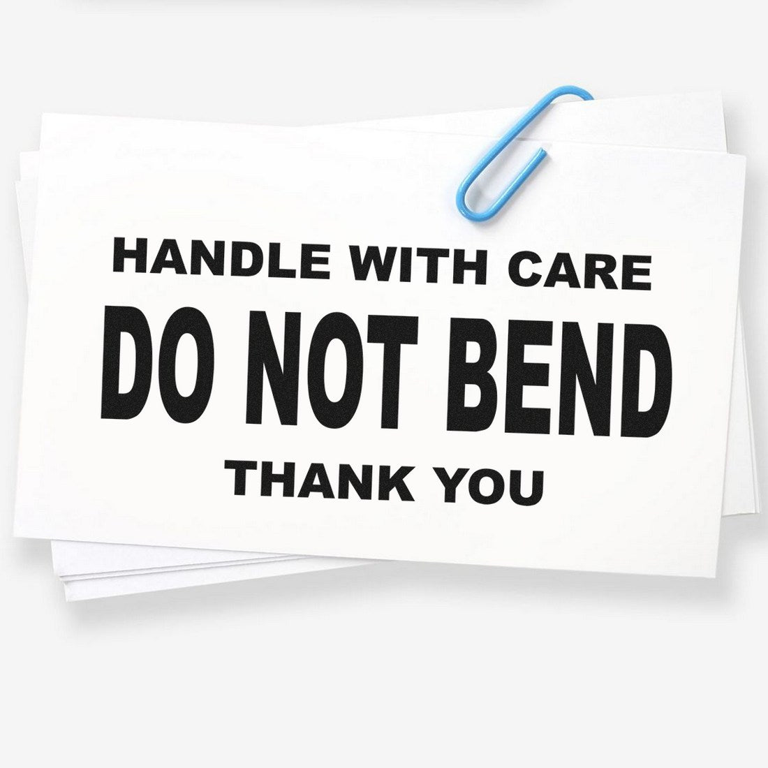 Wood Handle Handle With Care Do Not Bend Thank You Rubber Stamp on white paper, featuring bold black text and a blue paperclip. Ideal for packaging and shipping needs.