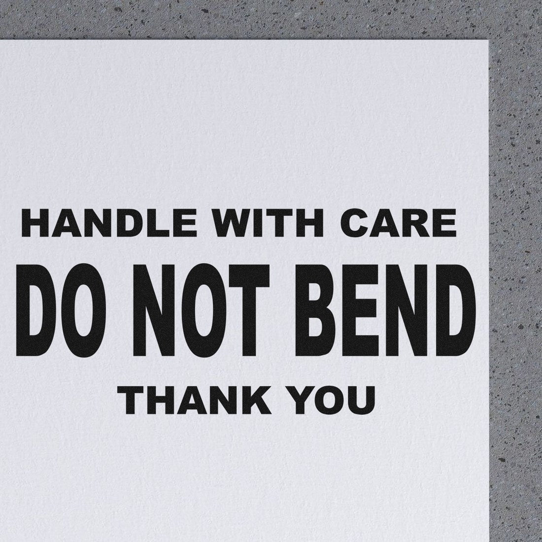 Self-Inking Handle With Care Do Not Bend Thank You Stamp on paper, showcasing bold black text for packaging and shipping needs.