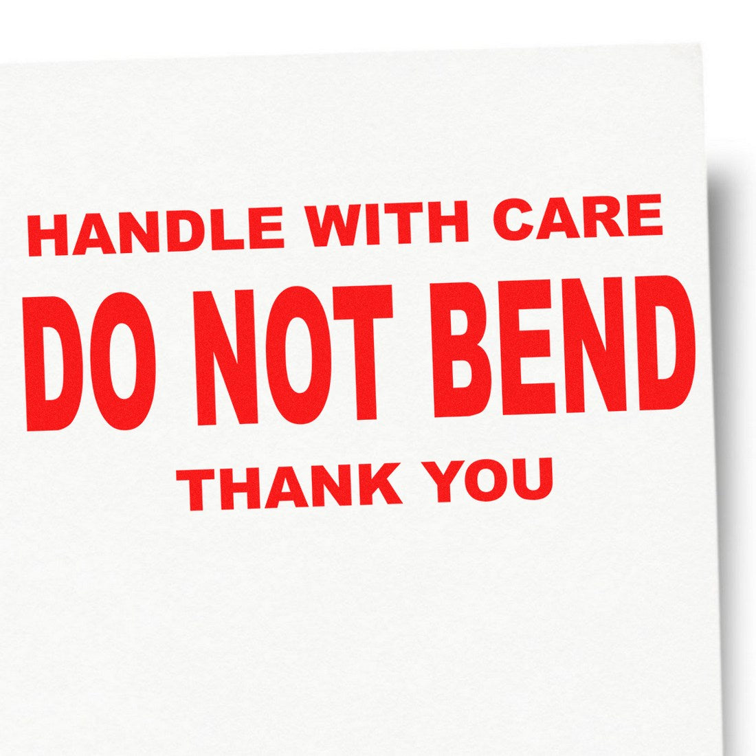 Self-Inking Handle With Care Do Not Bend Thank You Stamp in use, featuring bold red text on a white background, ideal for packaging and shipping needs.