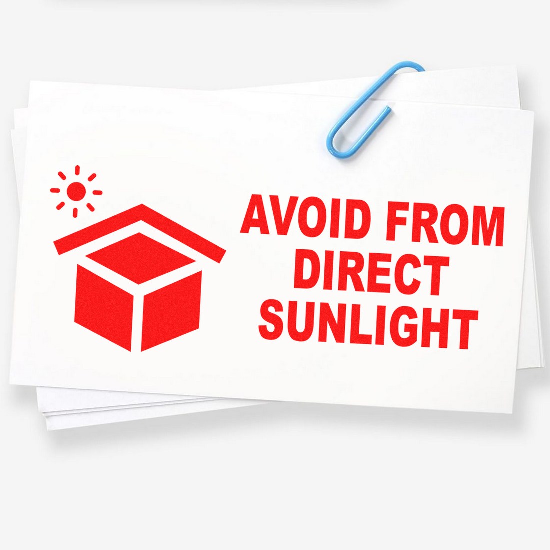 Self-Inking Sunlight Protection Warning Stamp with red icon and text 'Avoid from Direct Sunlight' on white paper, secured with a blue paperclip.