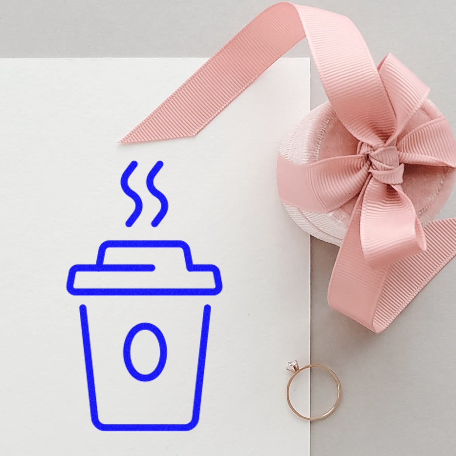 Self-Inking Java Joy Customer Loyalty Stamp with a blue coffee cup design, shown on white paper beside a pink ribbon and ring. Perfect for cafes to reward loyal customers.