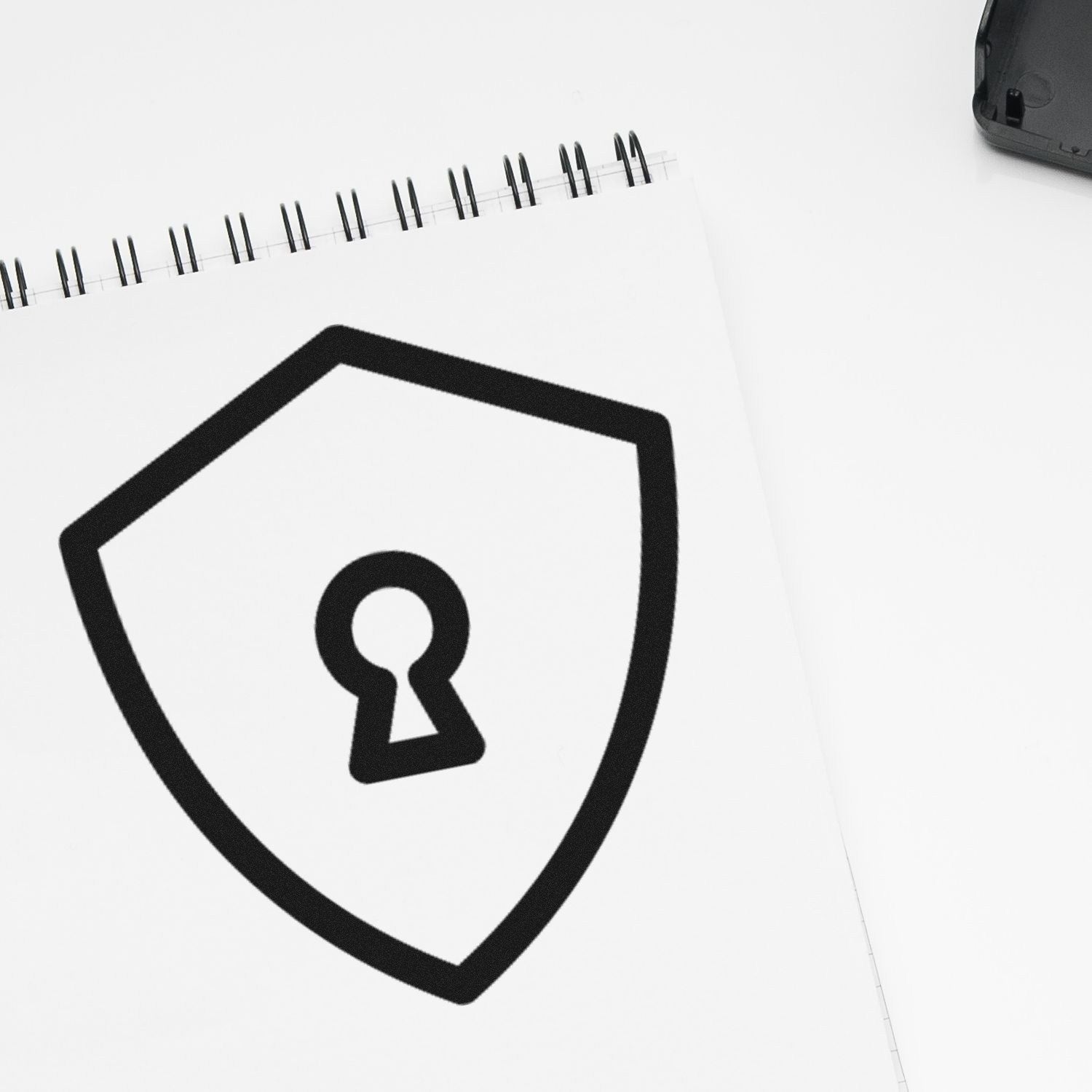 Wood Handle Secure Return Visit Rubber Stamp on a white notepad, featuring a black shield with a keyhole design, symbolizing security and privacy.