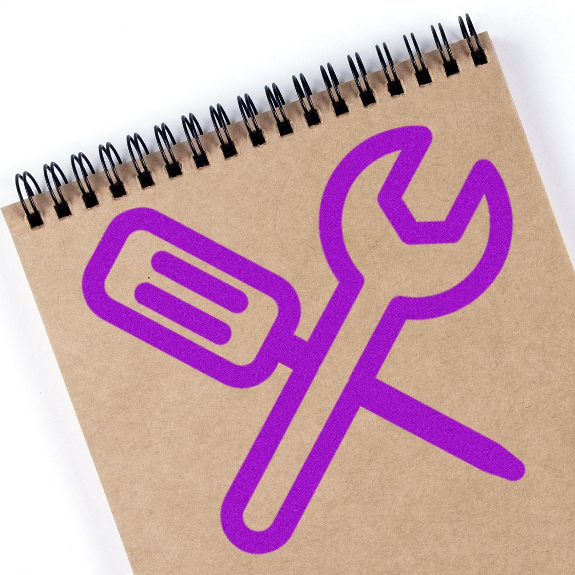 Self-Inking Gear Up! Punch Card Stamp with purple wrench and screwdriver design on a spiral-bound notebook. Ideal for tracking tasks and rewards.