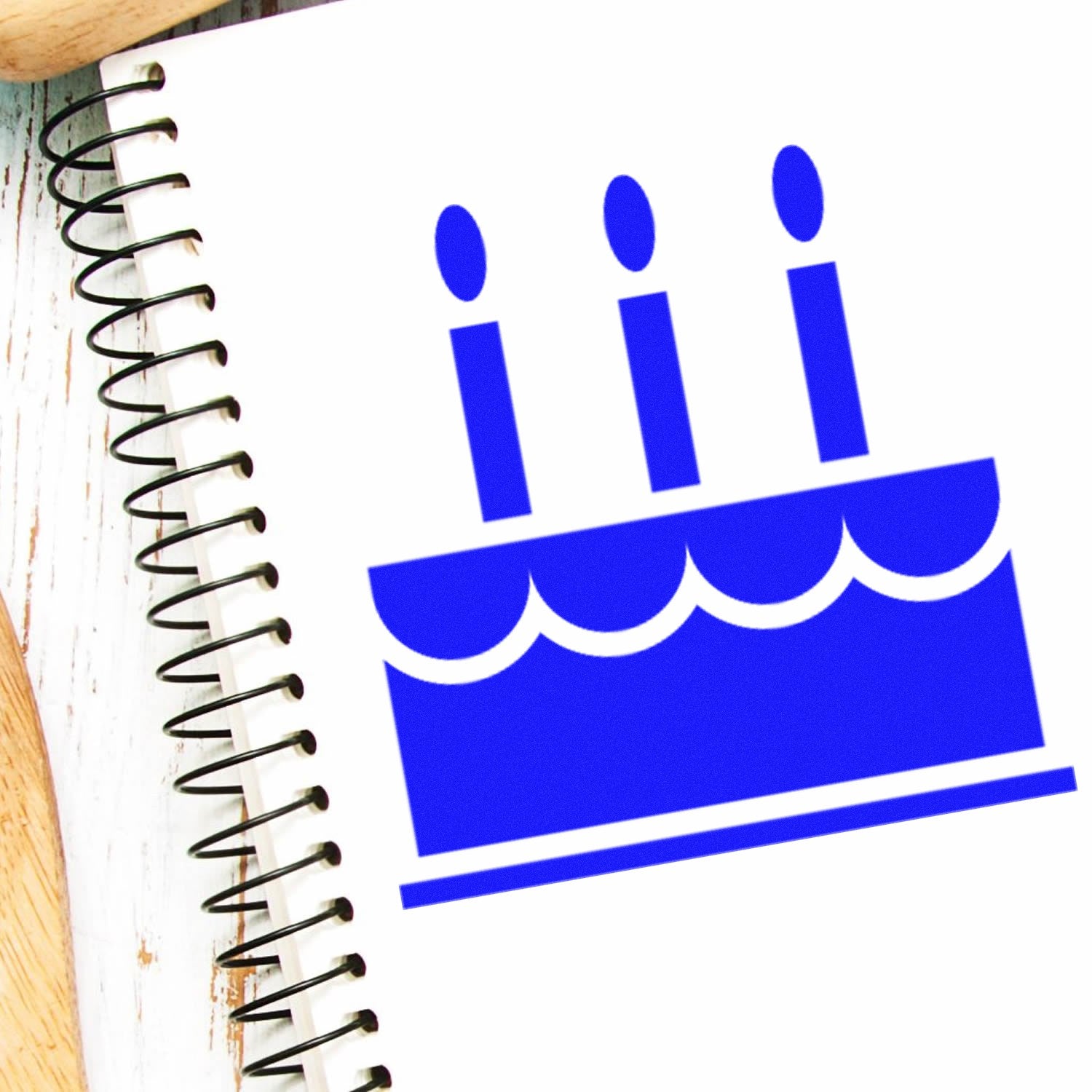 Self-Inking Cake Delight Incentive Stamp featuring a blue cake with candles design on a spiral notebook, perfect for rewarding achievements.