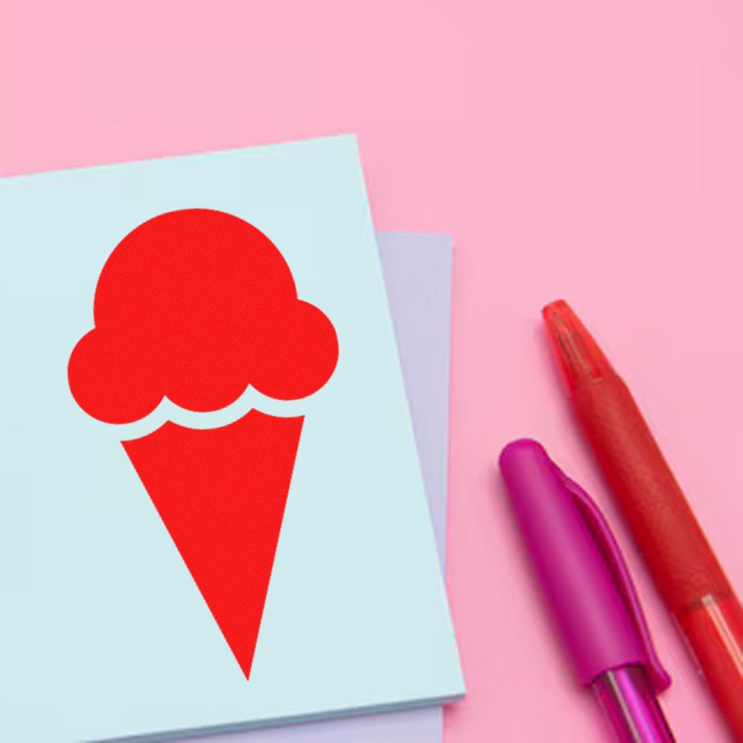 Self-Inking Ice Cream Delight Return Visit Stamp with a red ice cream cone design on pastel paper, accompanied by pink and red pens, against a pink background. Perfect for adding fun to documents.